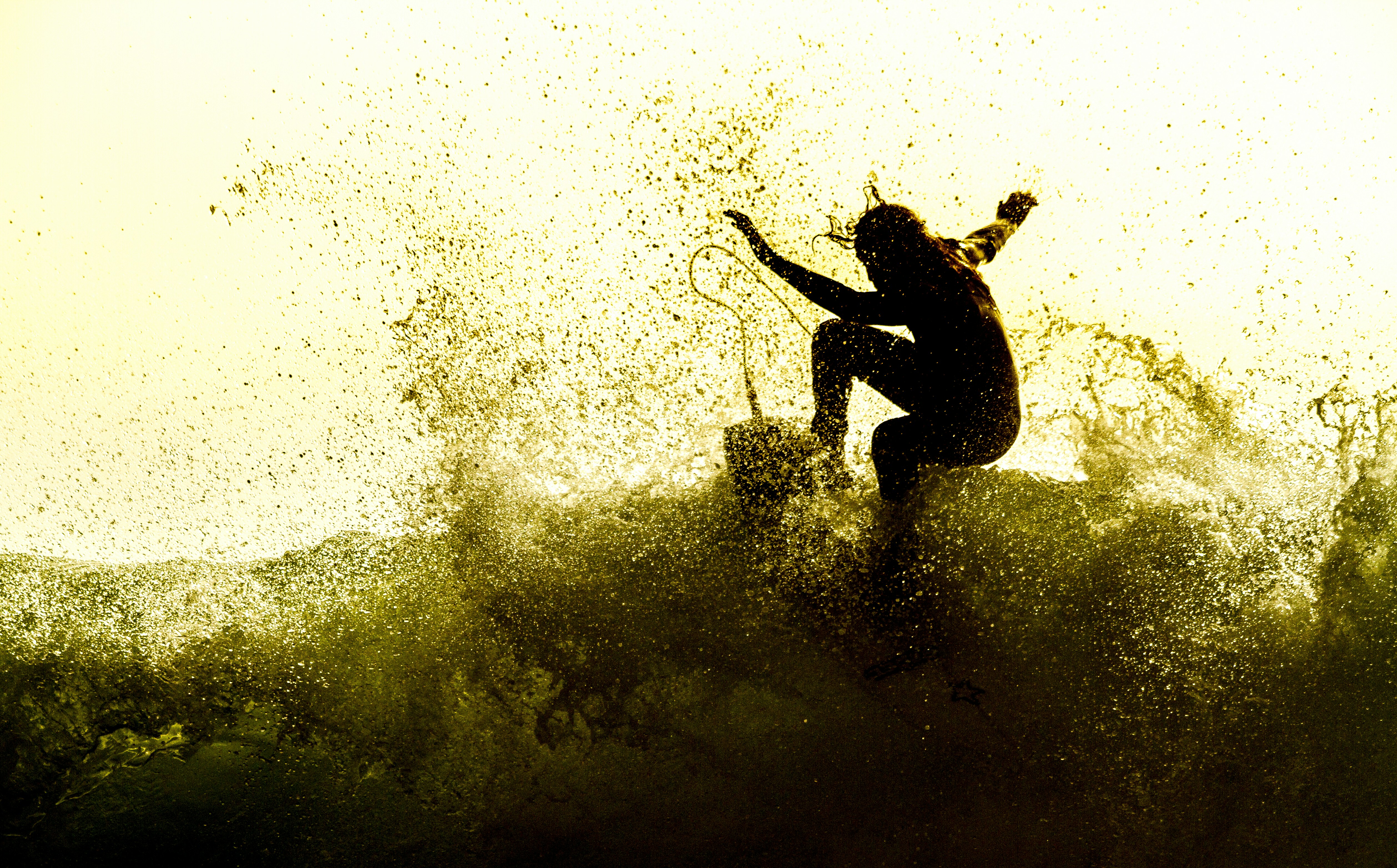 Silhouette of Surfer Riding Wave