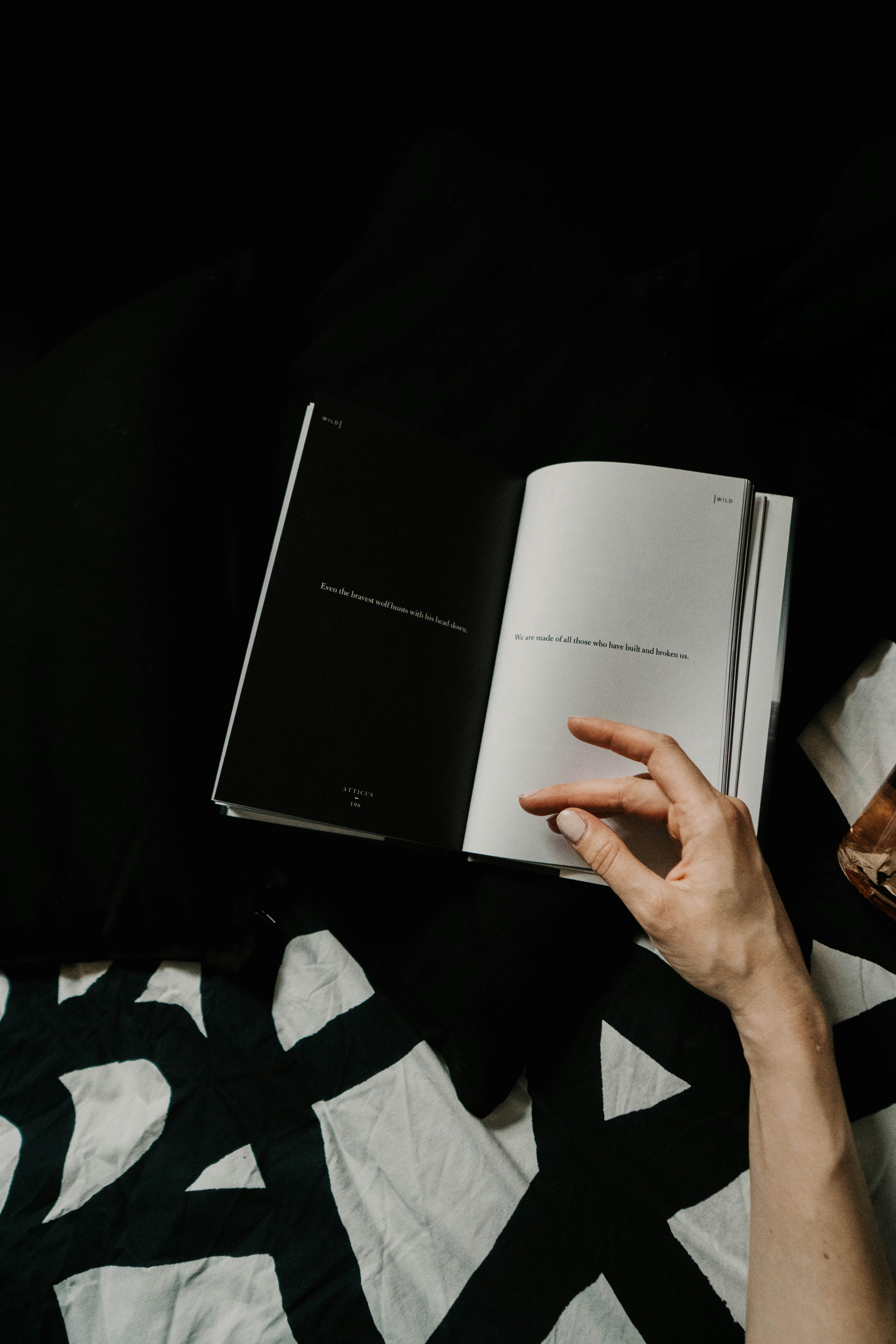 Open Poetry Book With Reader's Hand