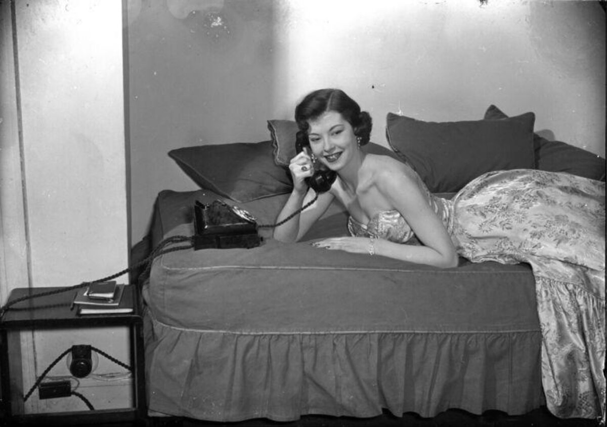 Woman Talking on Phone on Bed