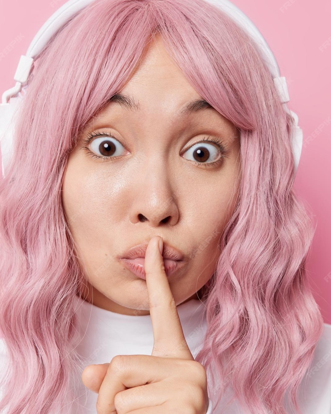 Woman with Pink Hair Making Shush Gesture