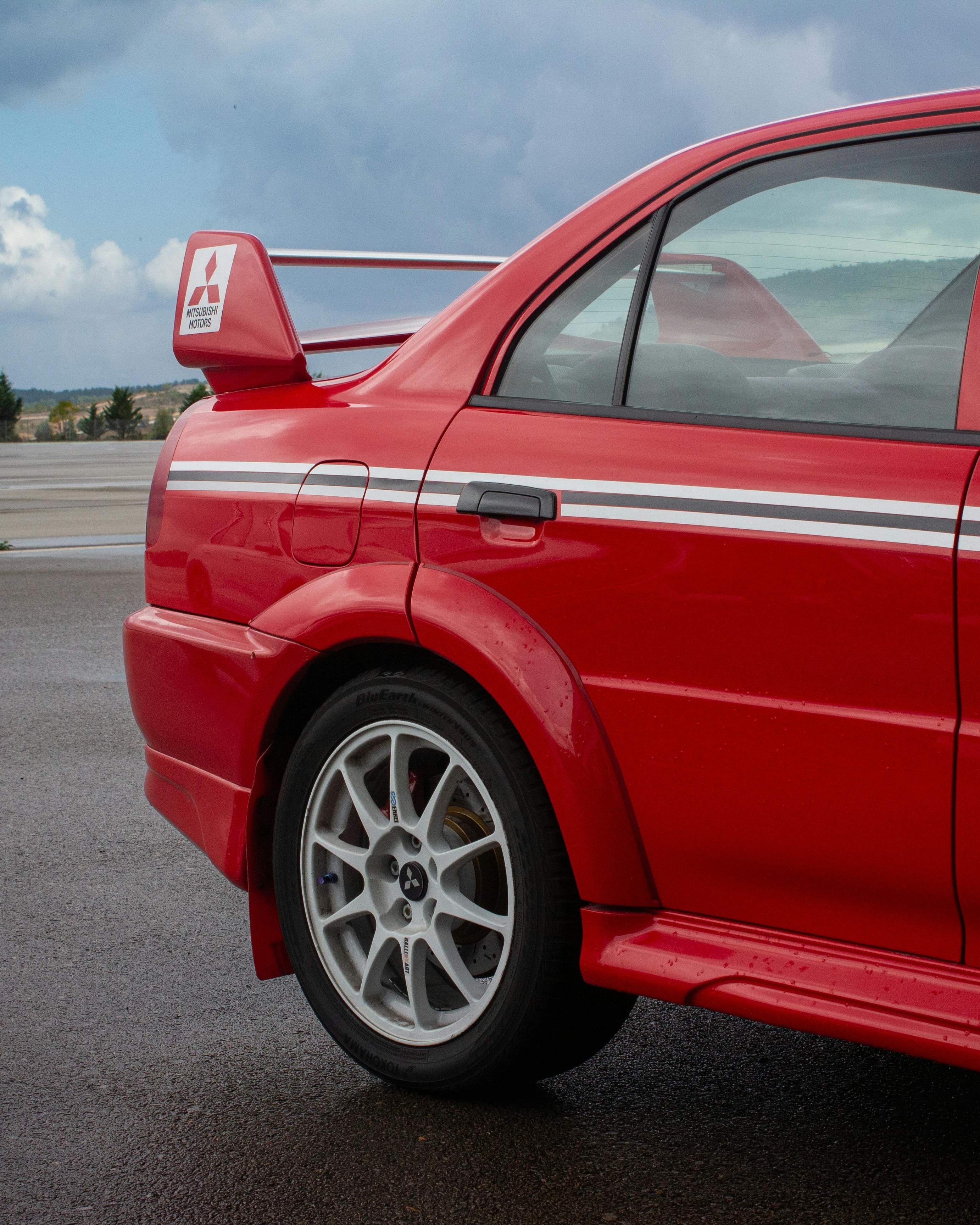 Red Mitsubishi Sports Sedan Rear Side View