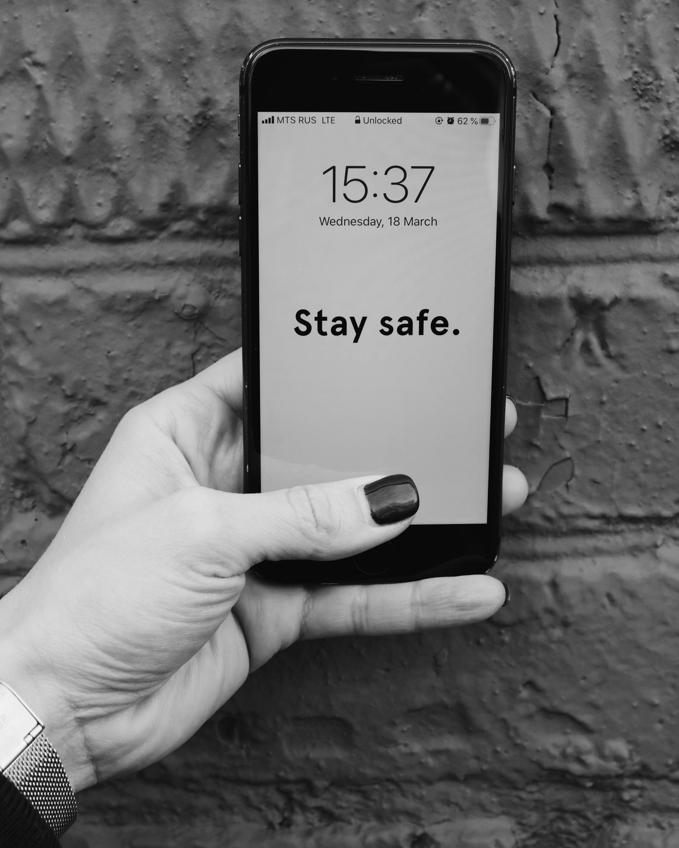 Hand Holding Phone With Stay Safe Message