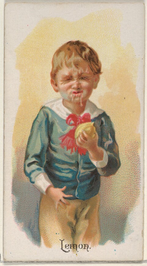 Boy Eating a Sour Lemon