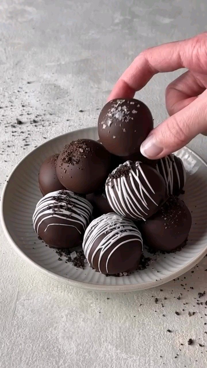 Hand Picking a Chocolate Truffle