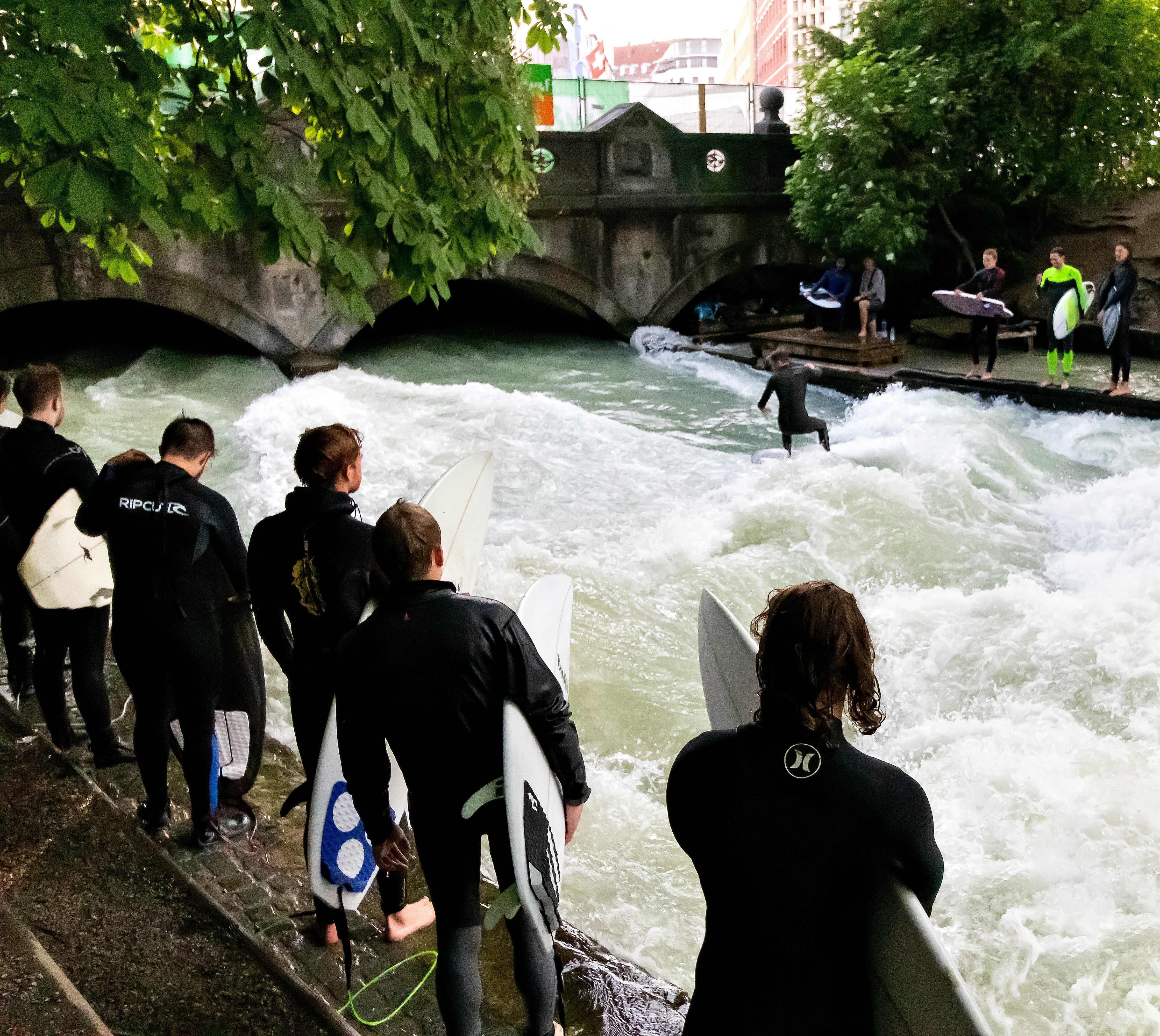 Urban River Surfing by Stone Bridge