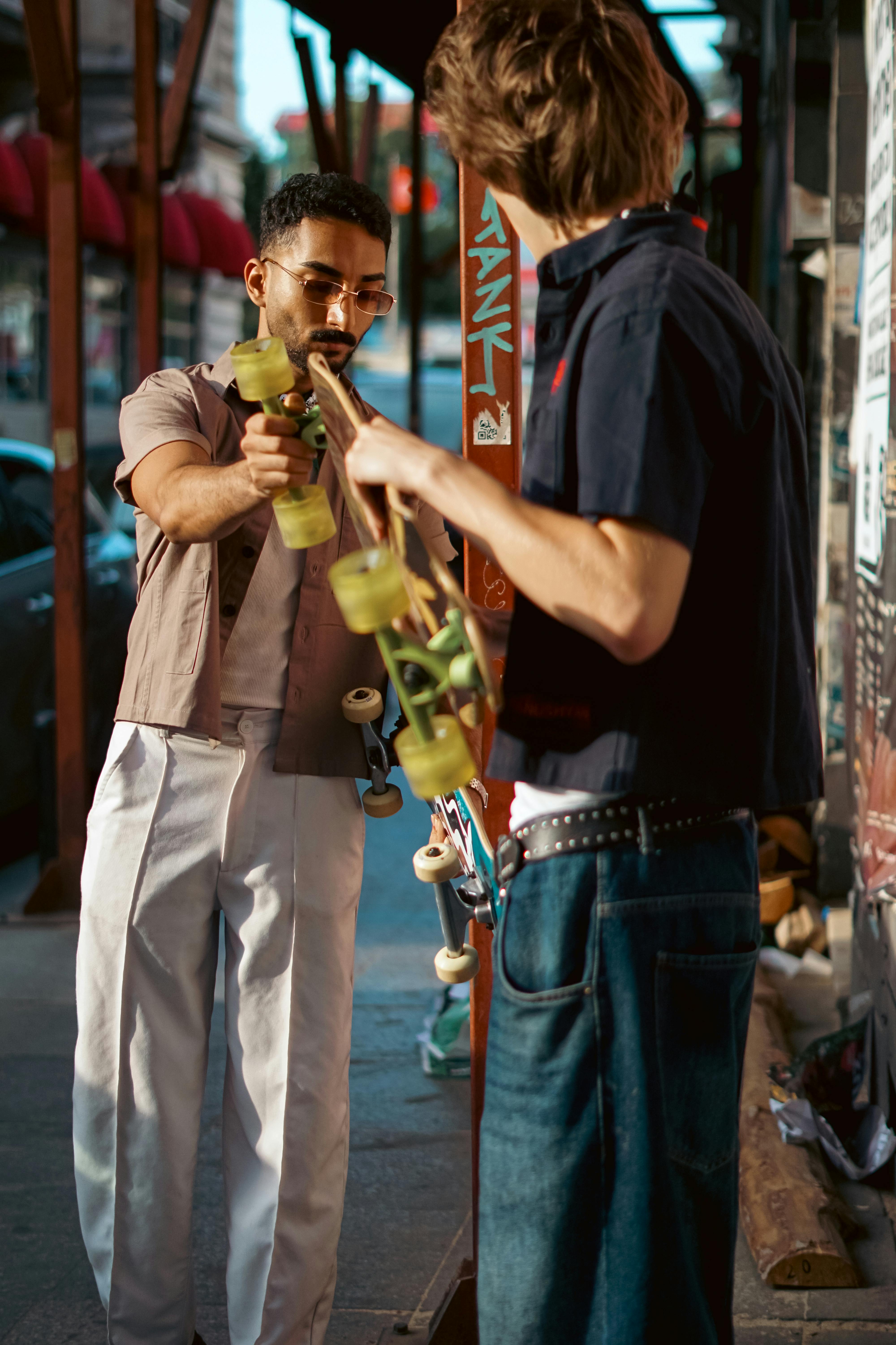 Two Men Checking Skateboards
