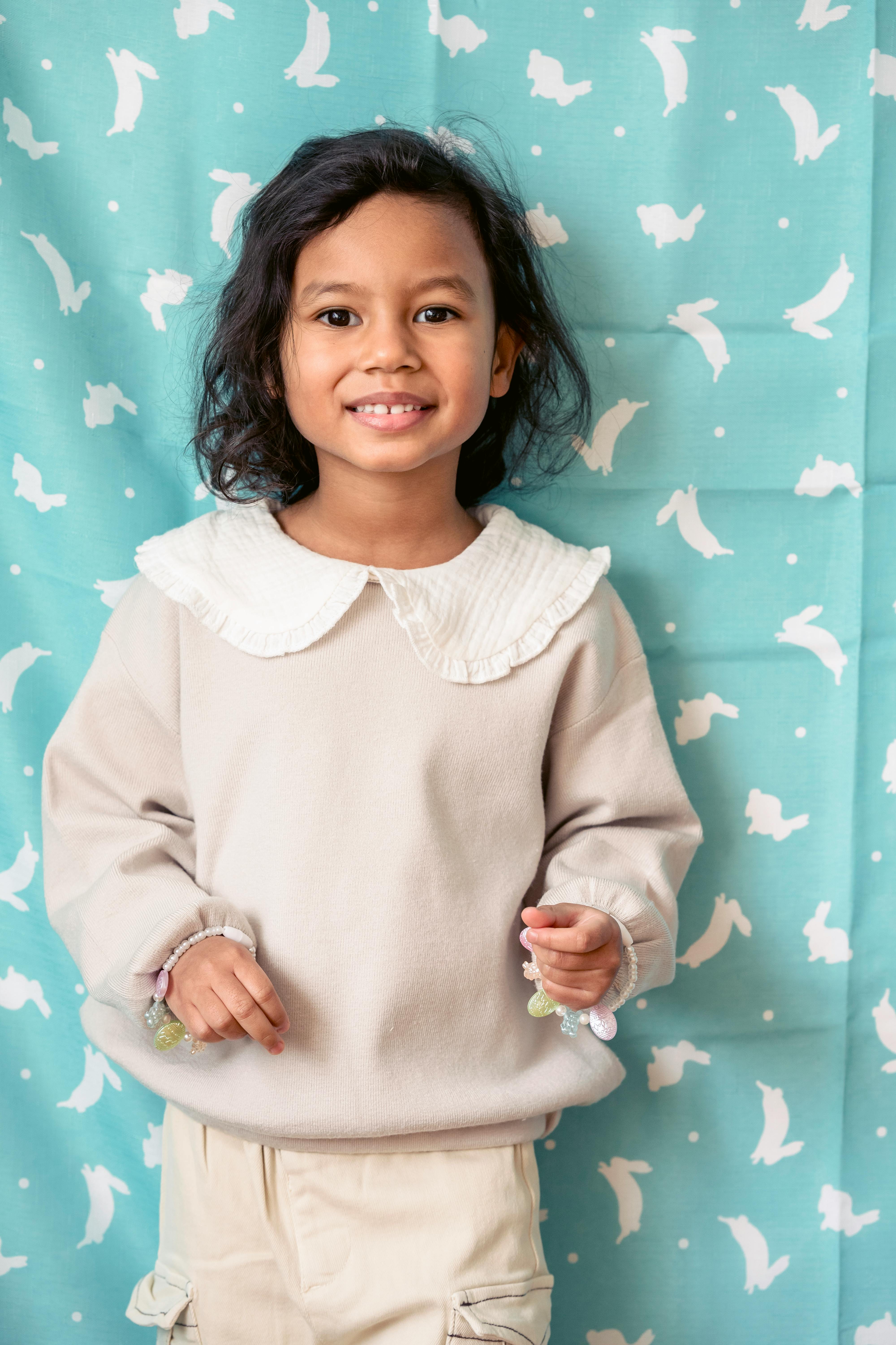 Smiling Young Girl Against Bunny Backdrop