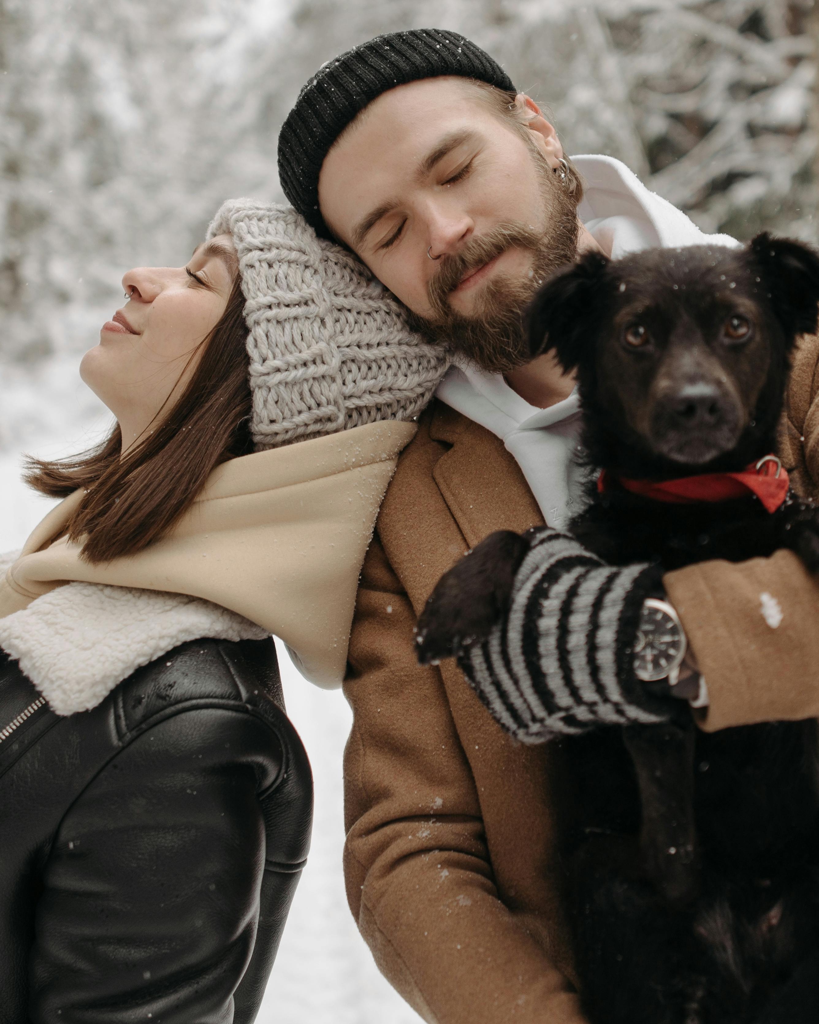 Couple With Dog In Winter Snow