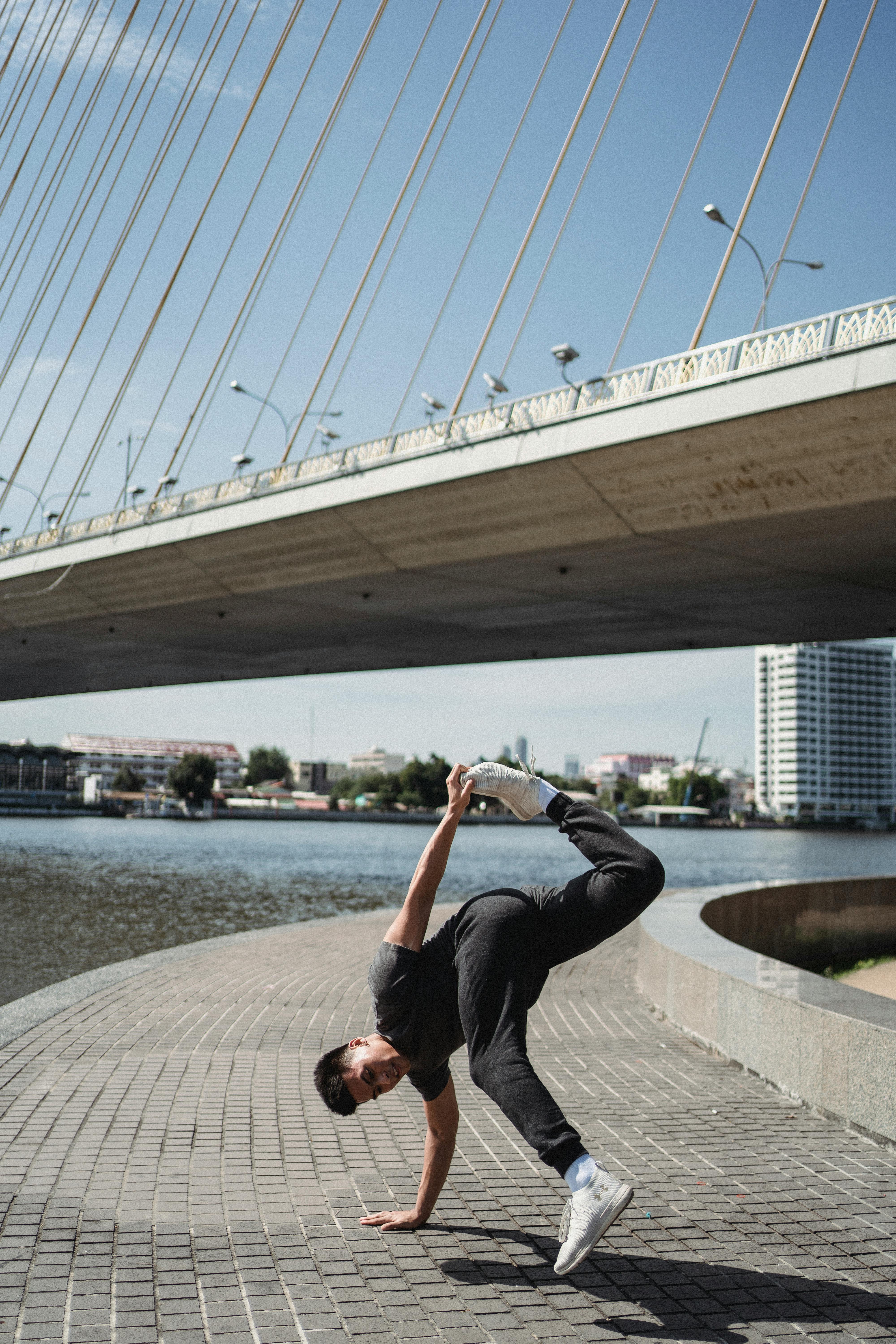 Breakdancer Practicing Under Cable Bridge