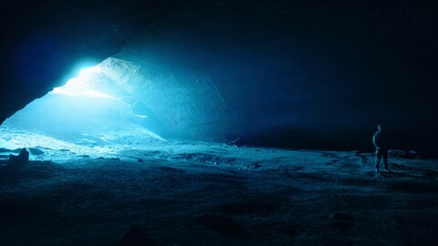Explorer in Blue Ice Cave