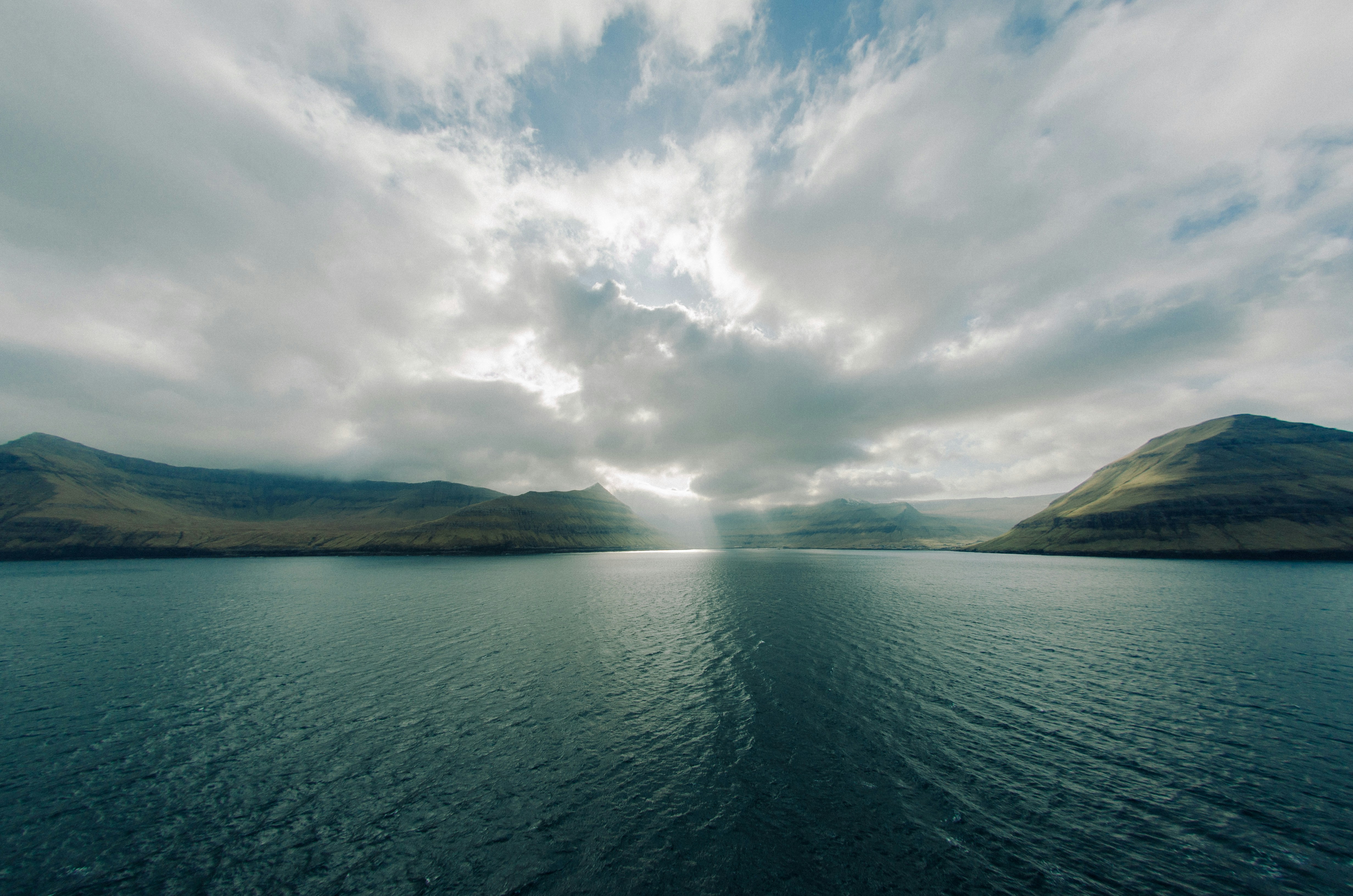 Calm Sea Between Rolling Mountains