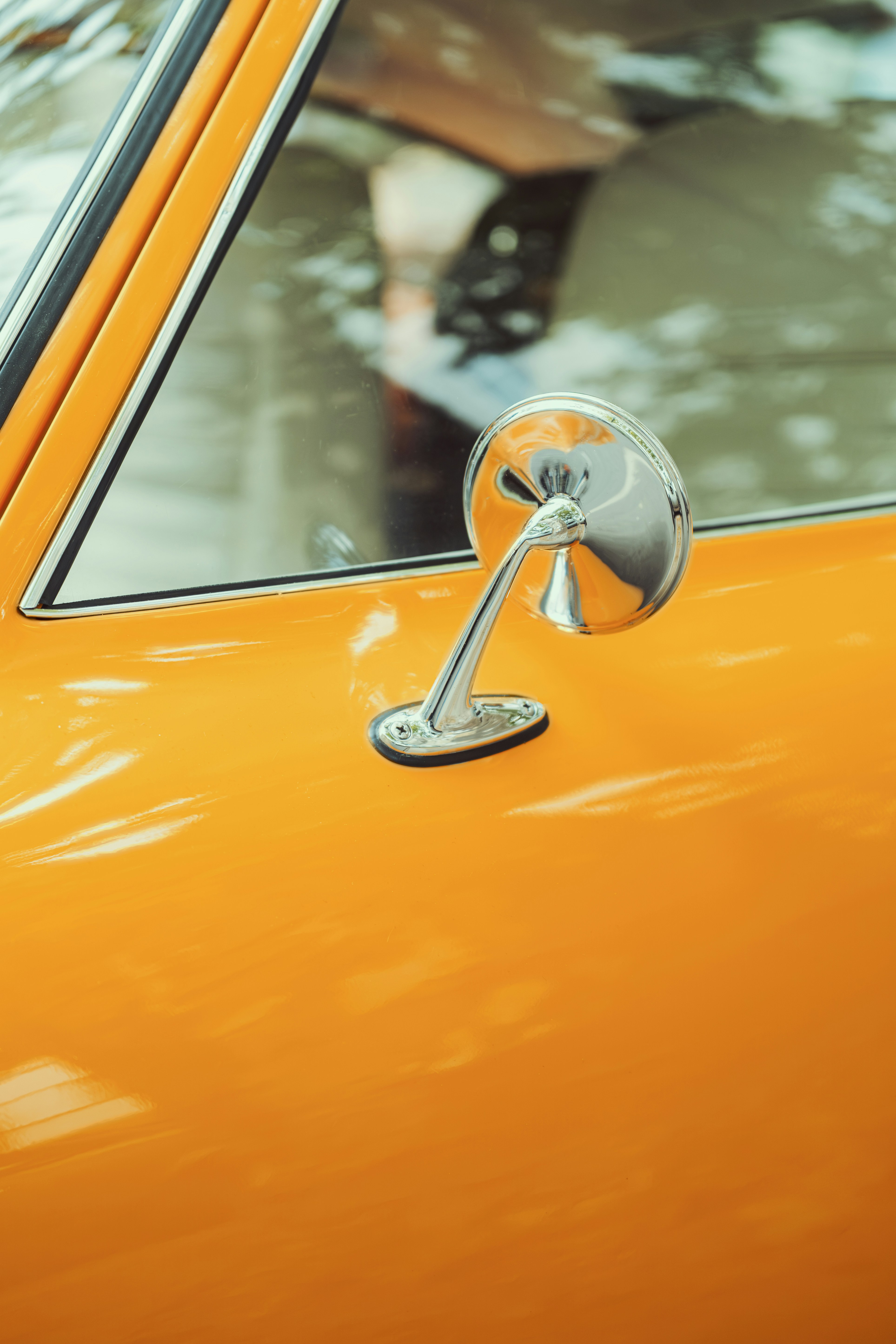 Close-up of Orange Vintage Car Side Mirror