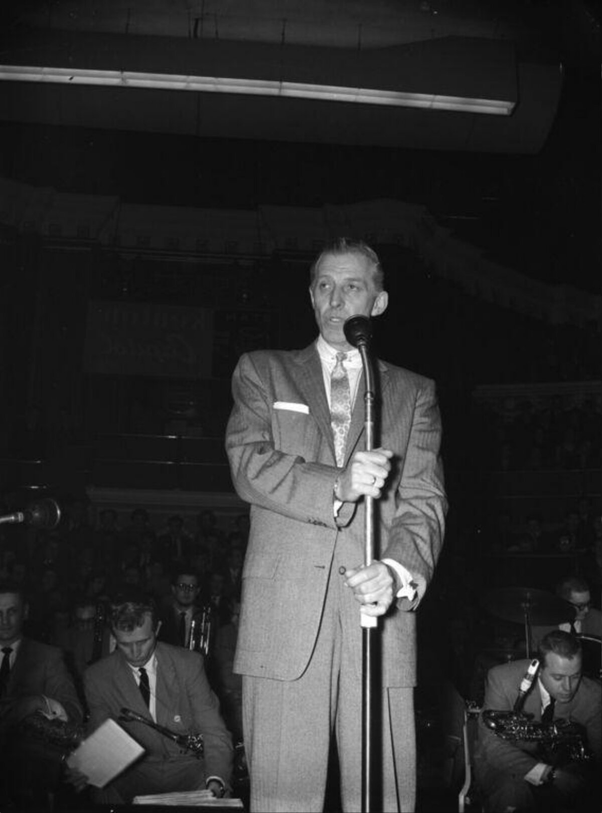 Orchestra Leader Speaking at Microphone