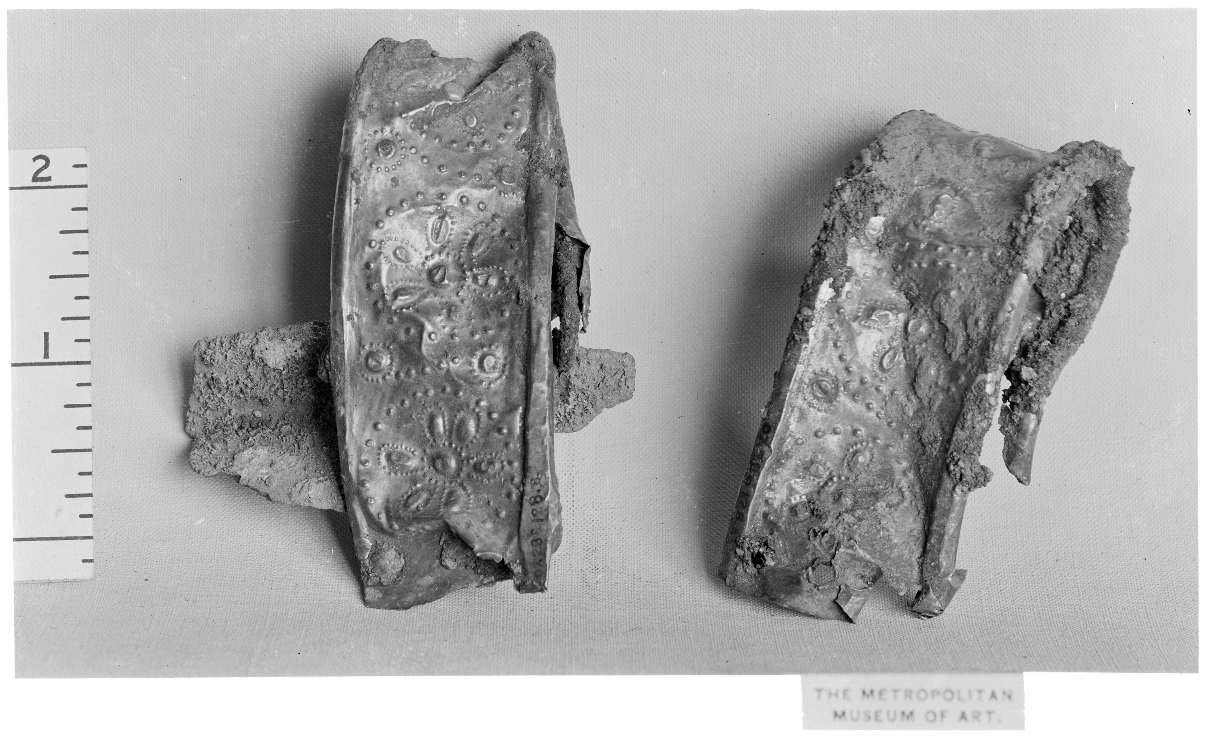 Two Decorated Metal Artifact Fragments