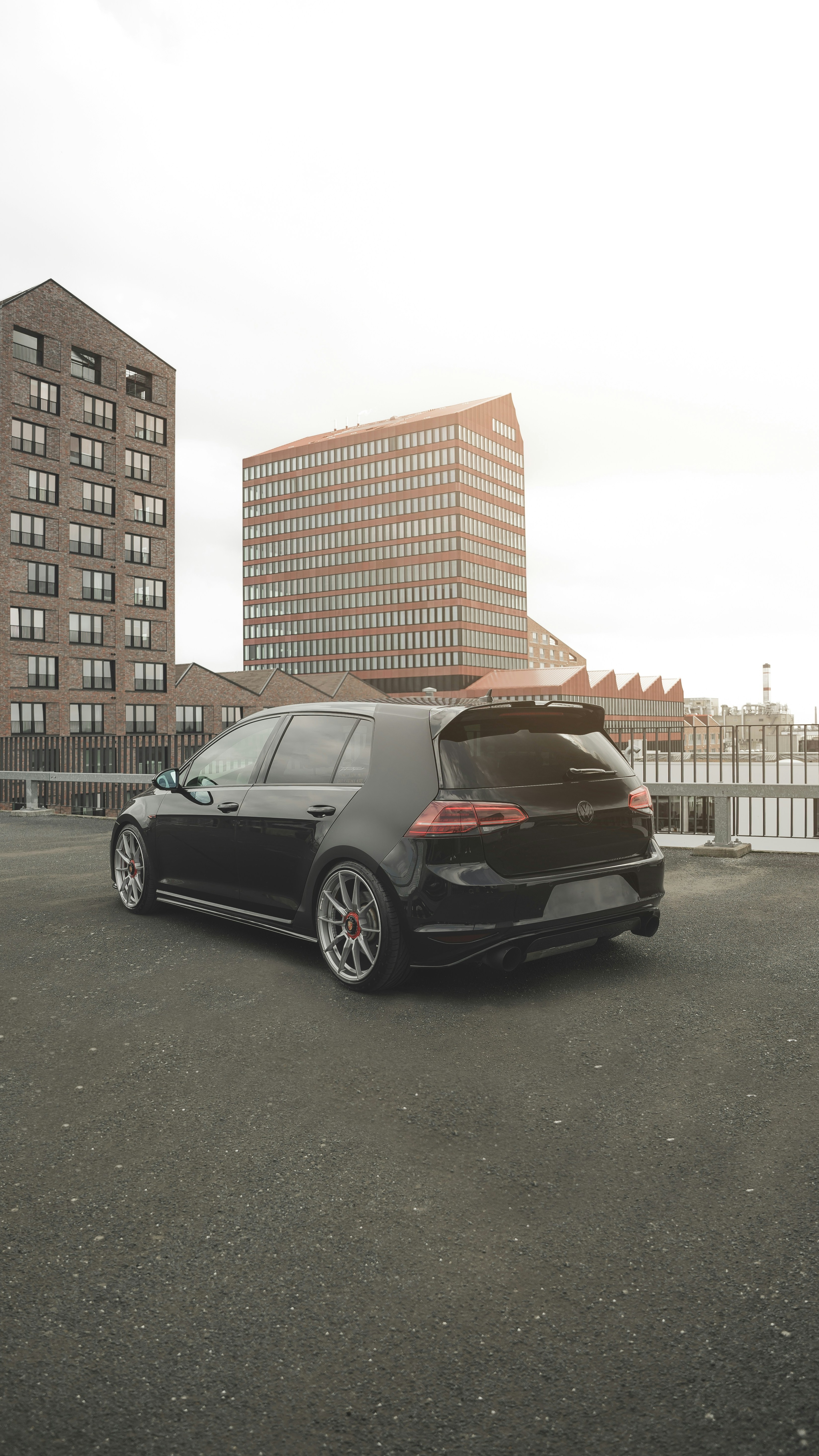 Black Modified Golf Hatchback on Rooftop Parking