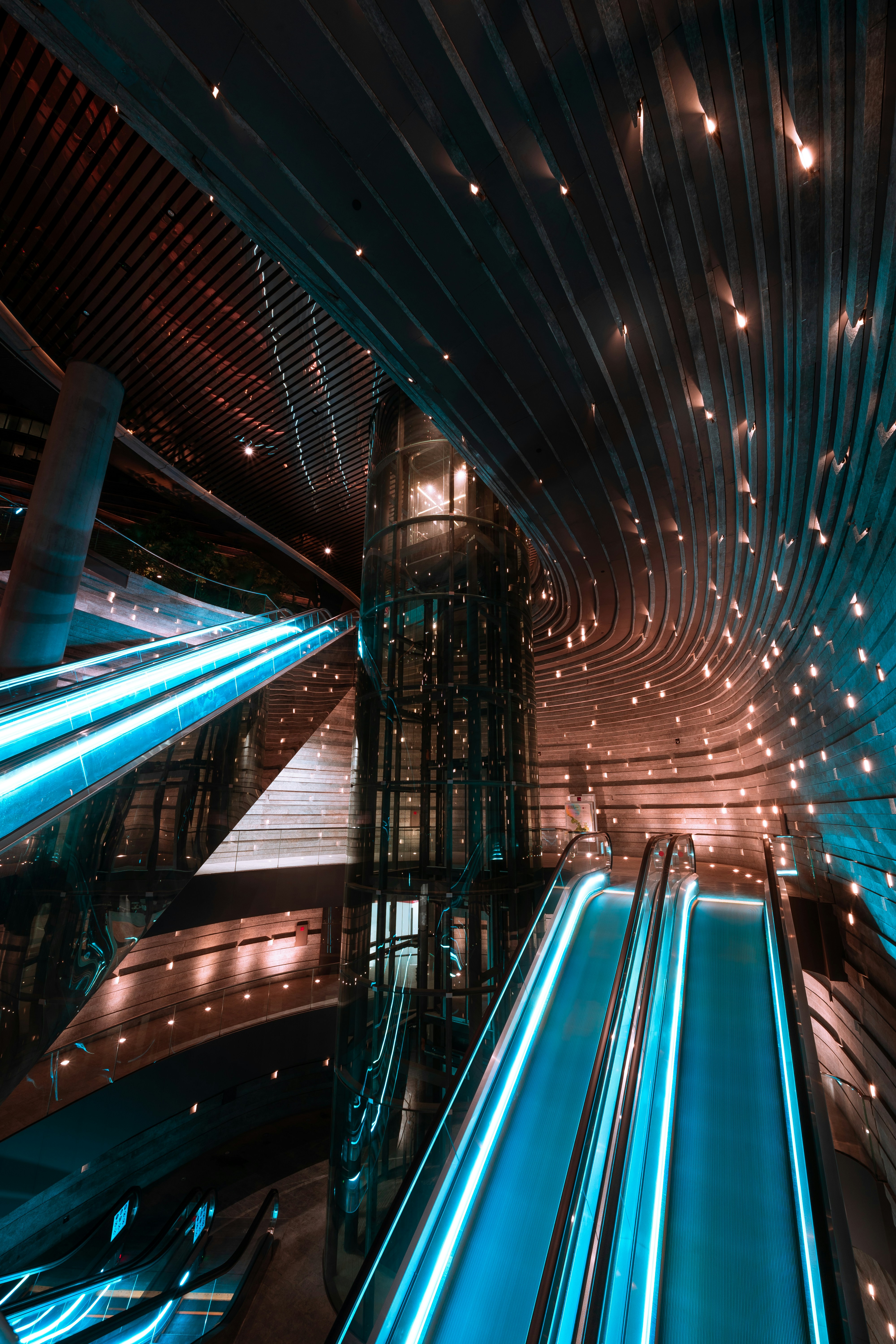 Blue-Lit Modern Indoor Escalator Atrium