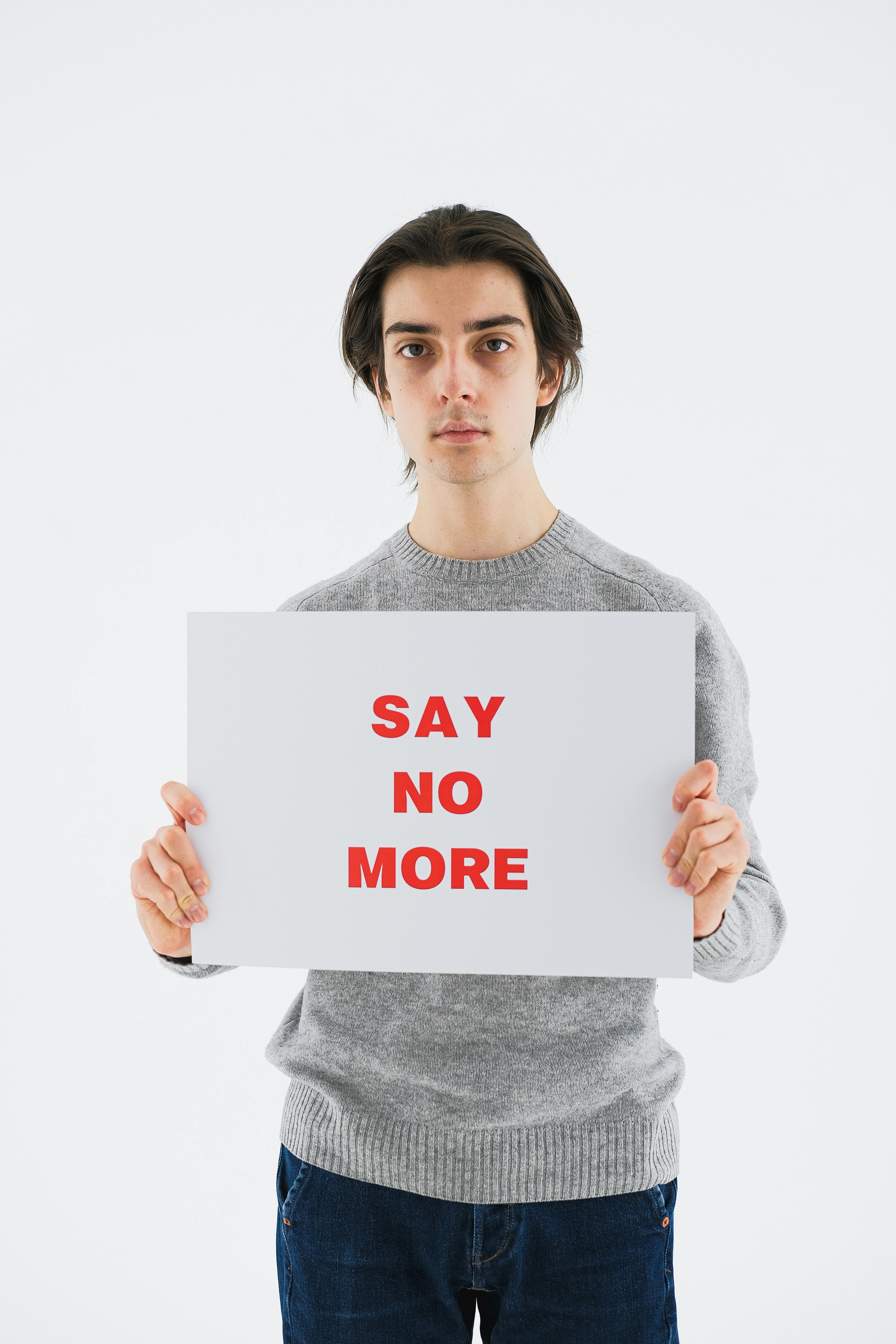 Man Holding Say No More Sign
