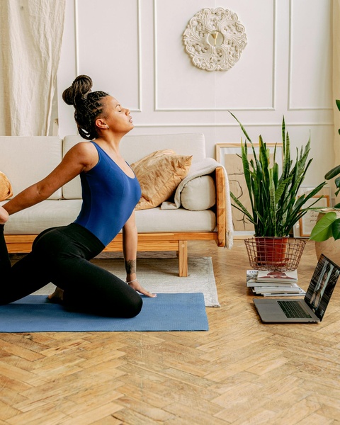 Woman Practicing Online Yoga At Home