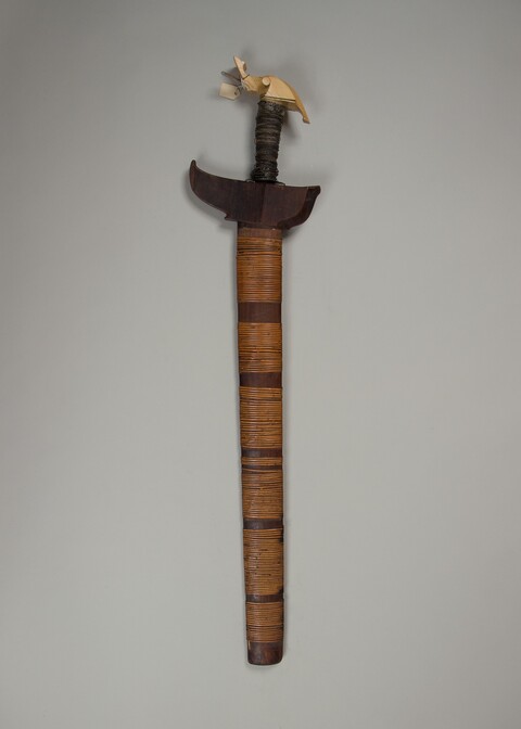 Traditional Sword with Carved Hilt and Woven Scabbard