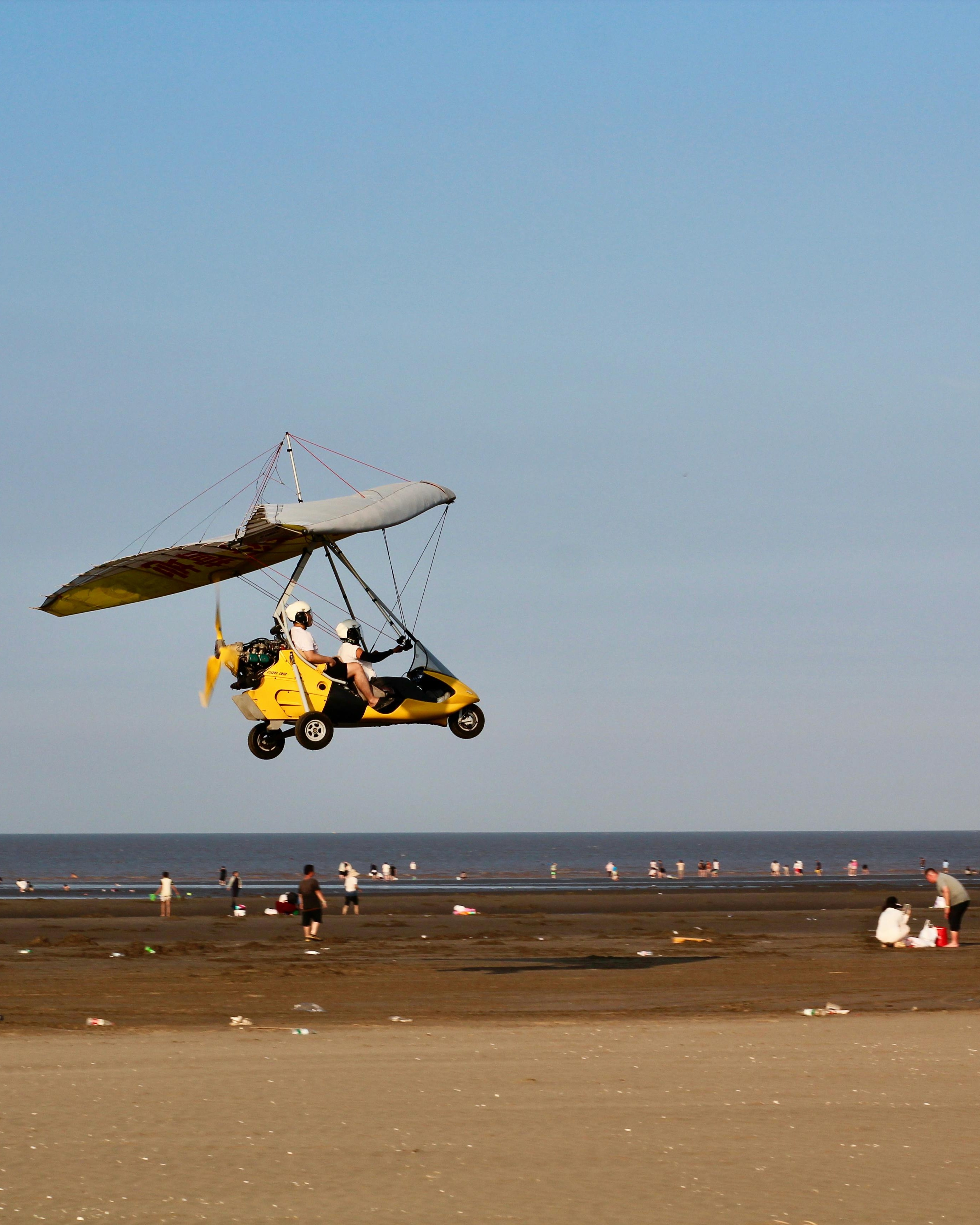 Ultralight Glider Flying Over Beach