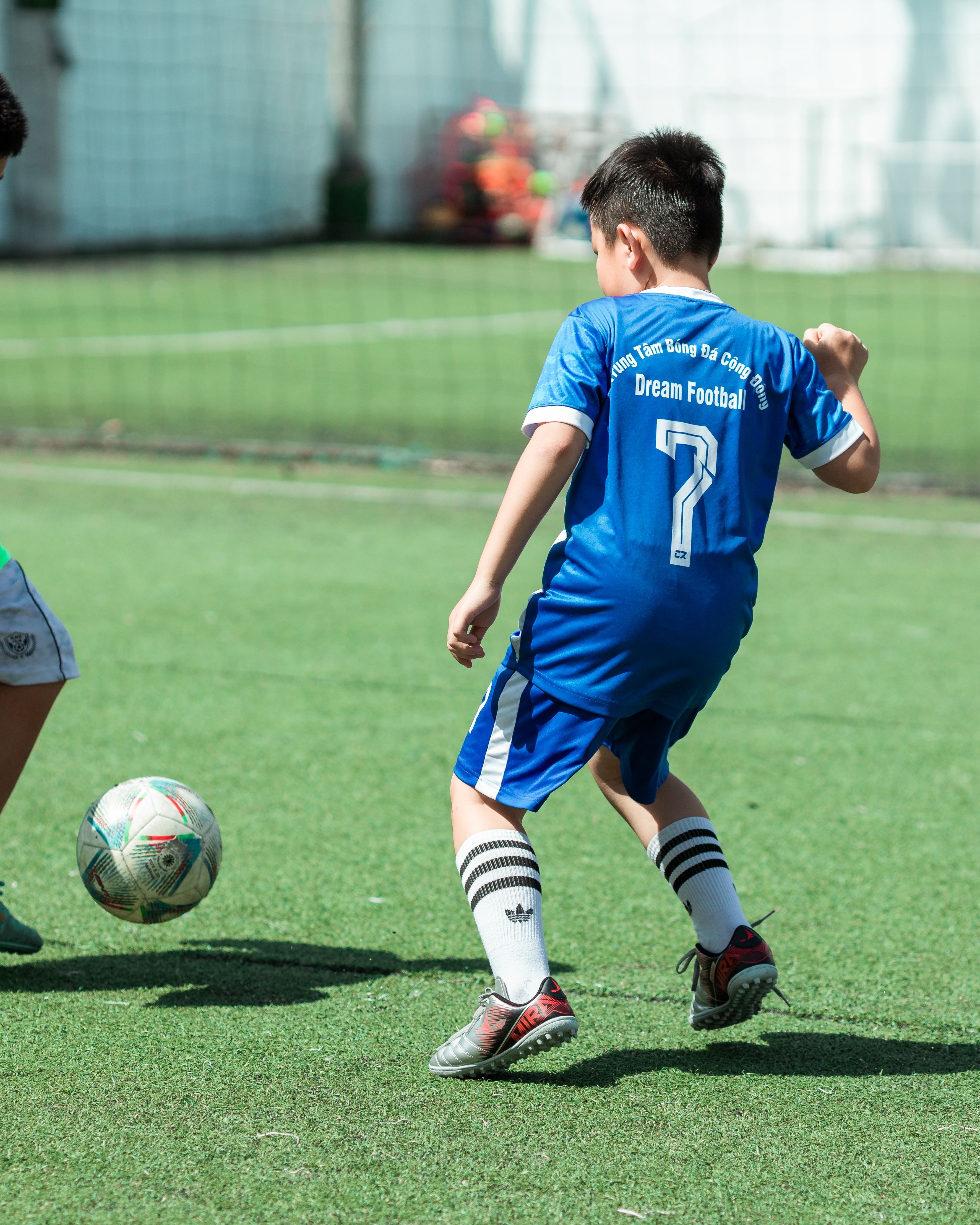 Boy Playing Soccer on Field