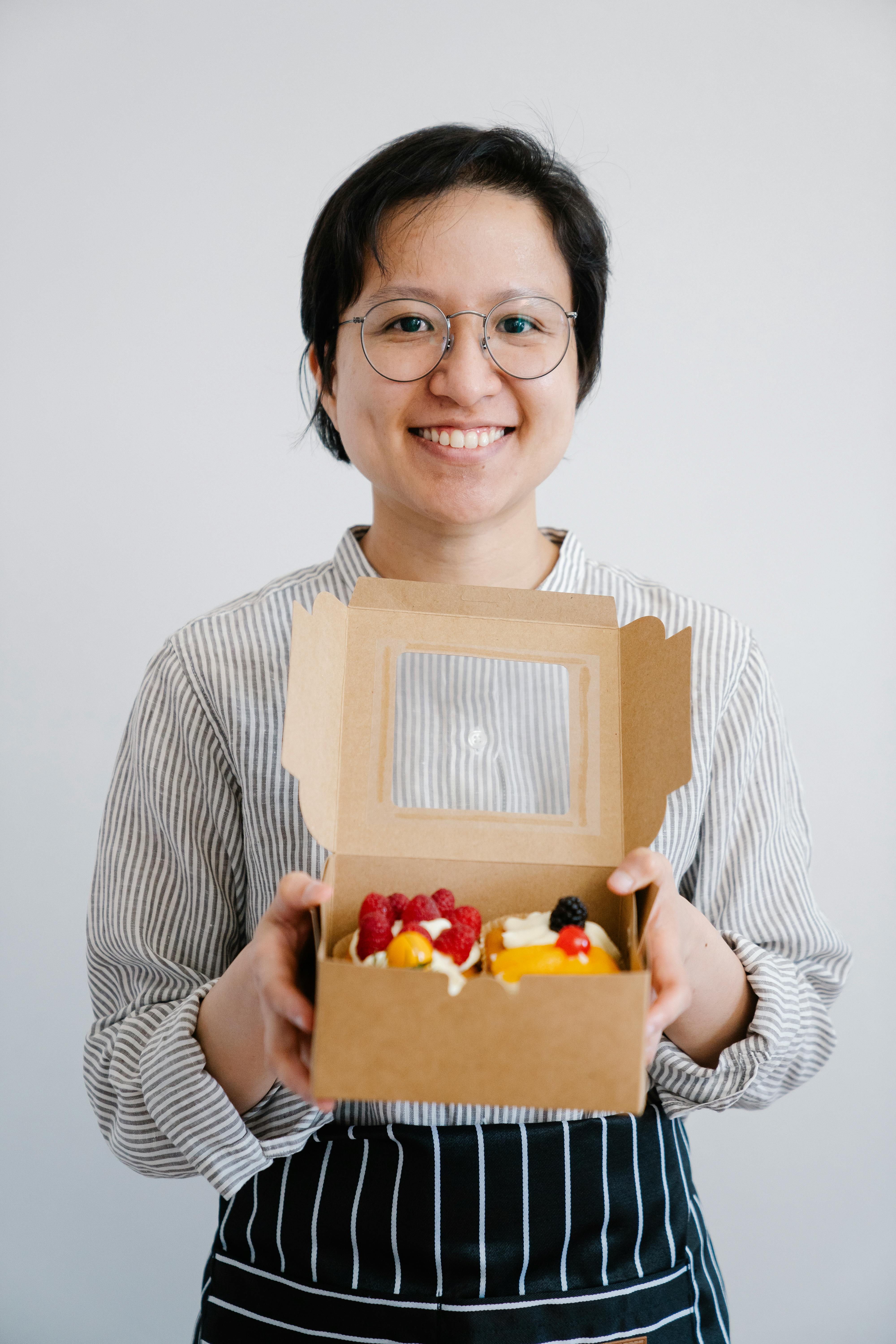 Baker Holding Box of Fruit Tarts