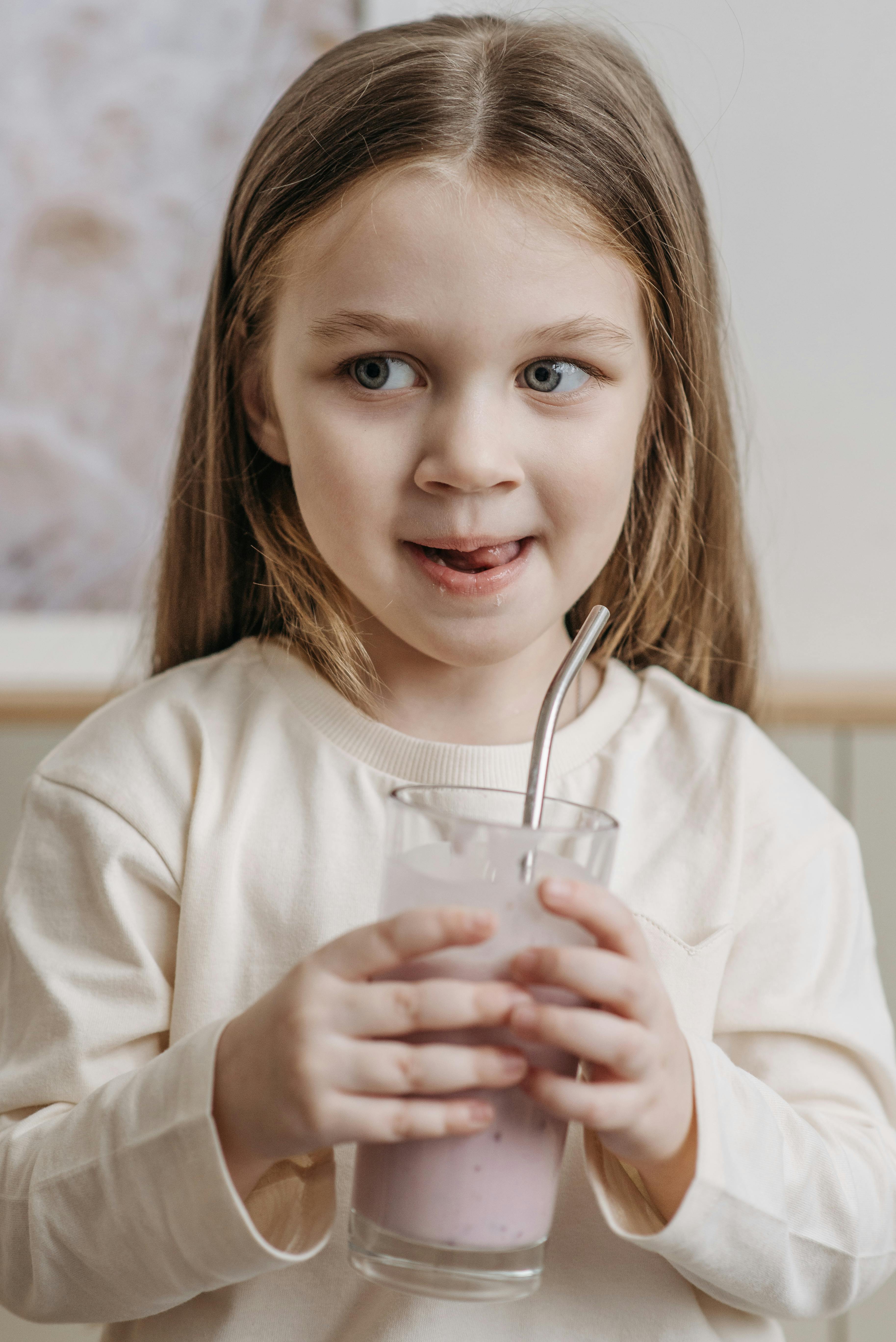 Little Girl Holding Pink Smoothie