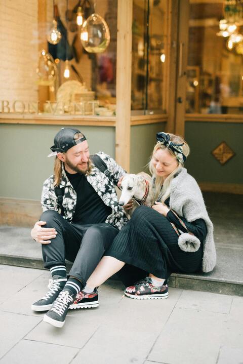 Couple with dog outside a storefront