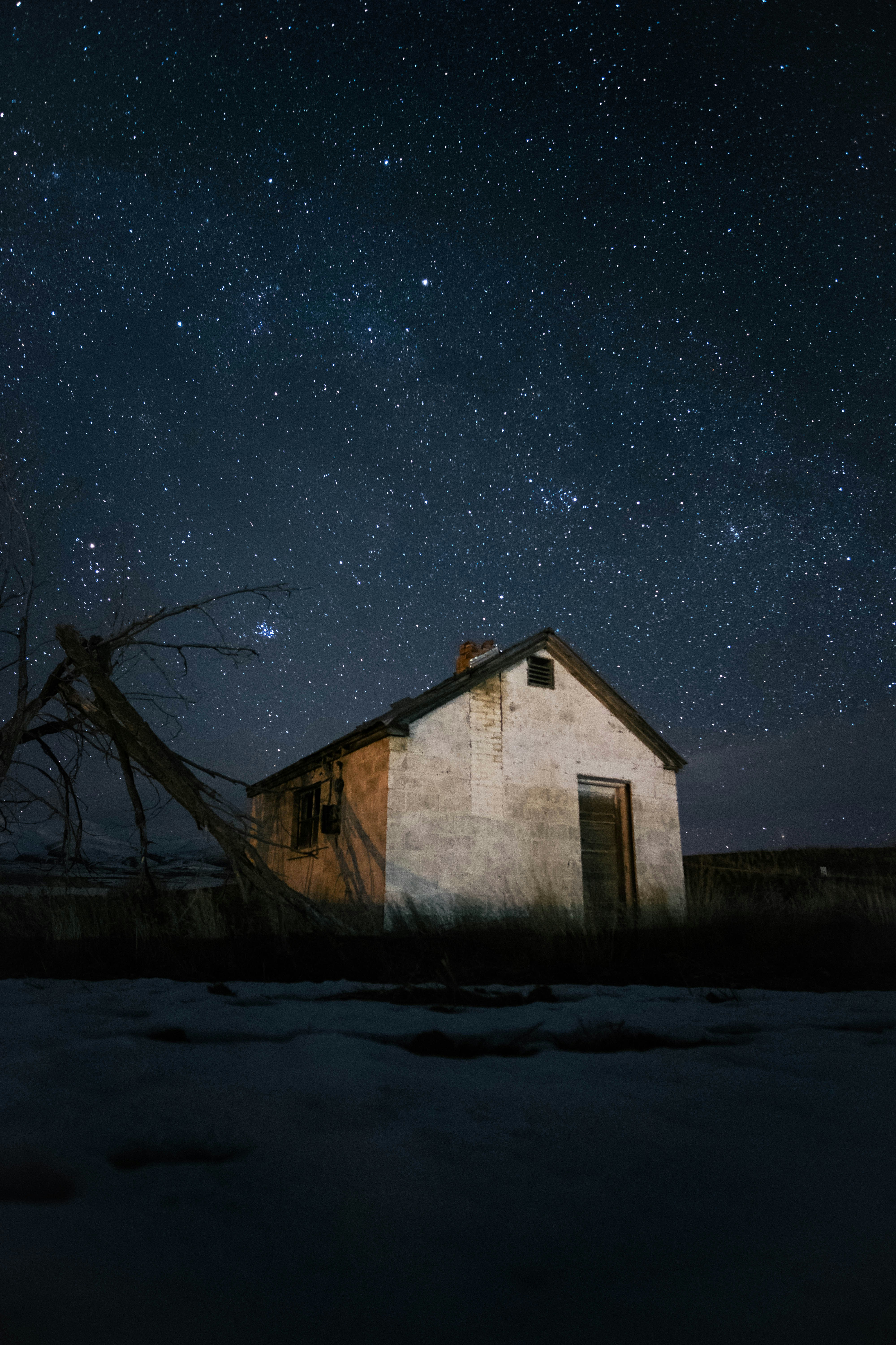 Abandoned Cottage Under Starry Night Sky
