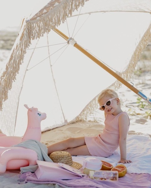Little Girl Relaxing at Beach Picnic