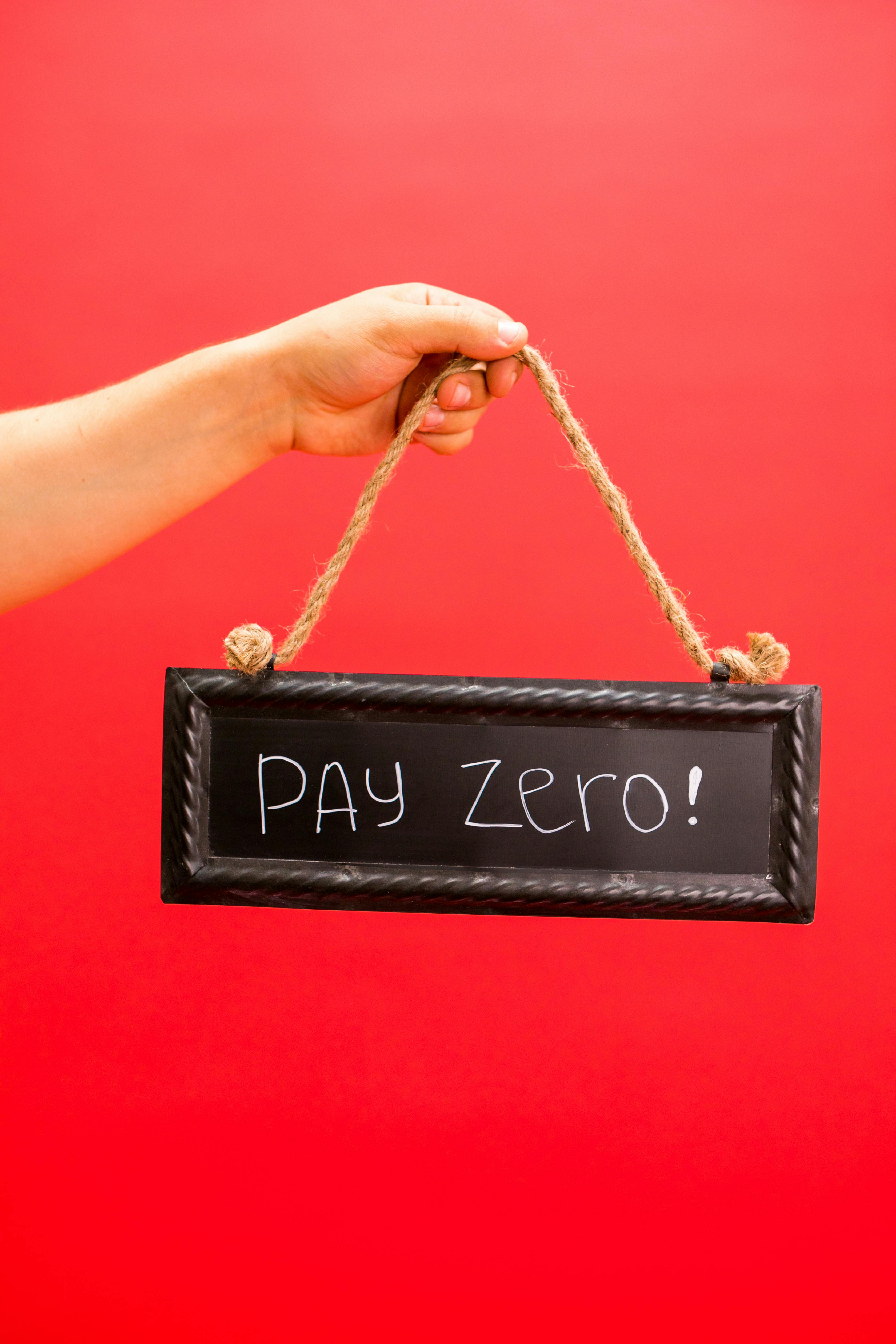 Hand Holding Pay Zero Sign