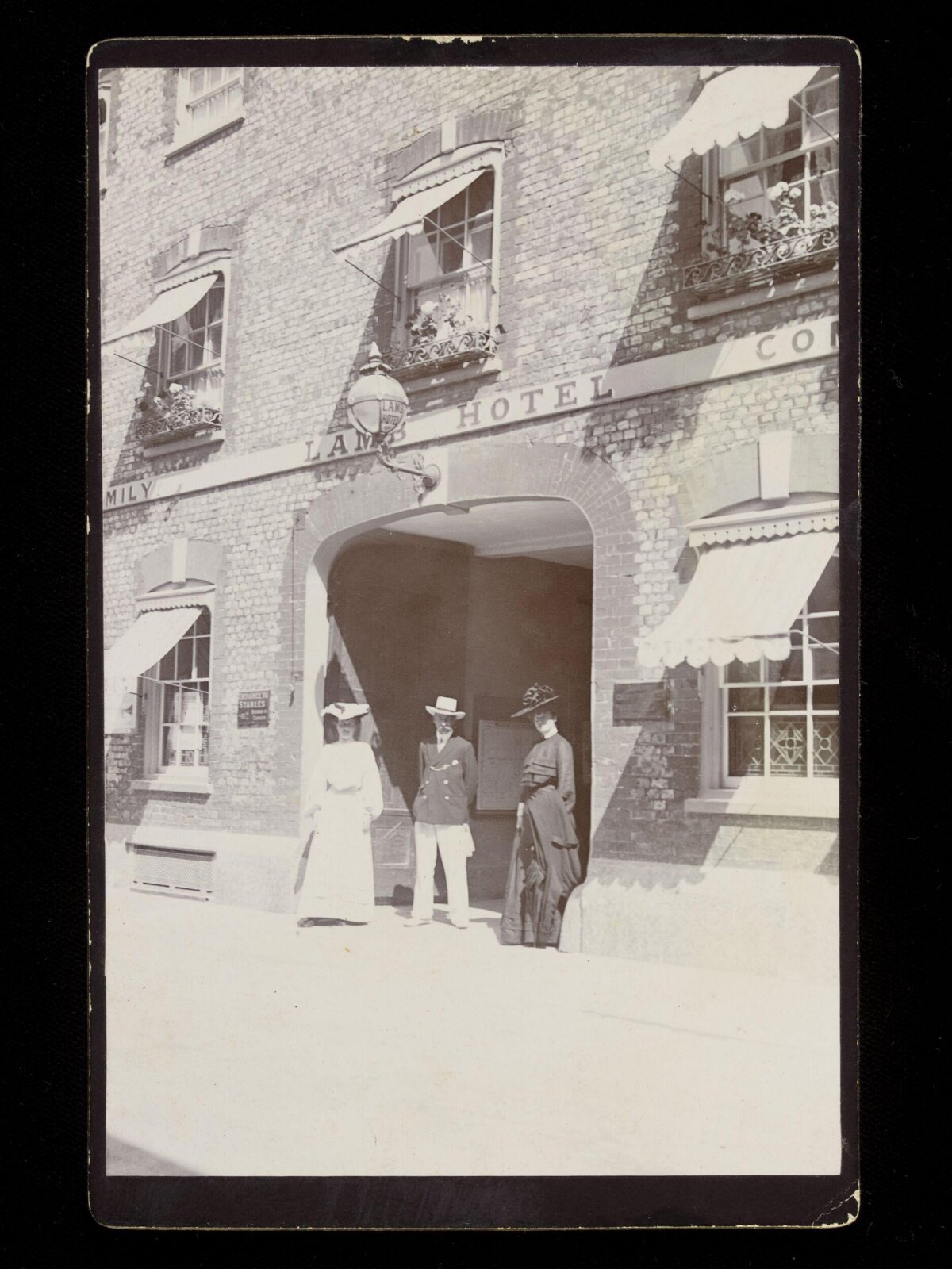 Three People at Lamb Hotel Entrance
