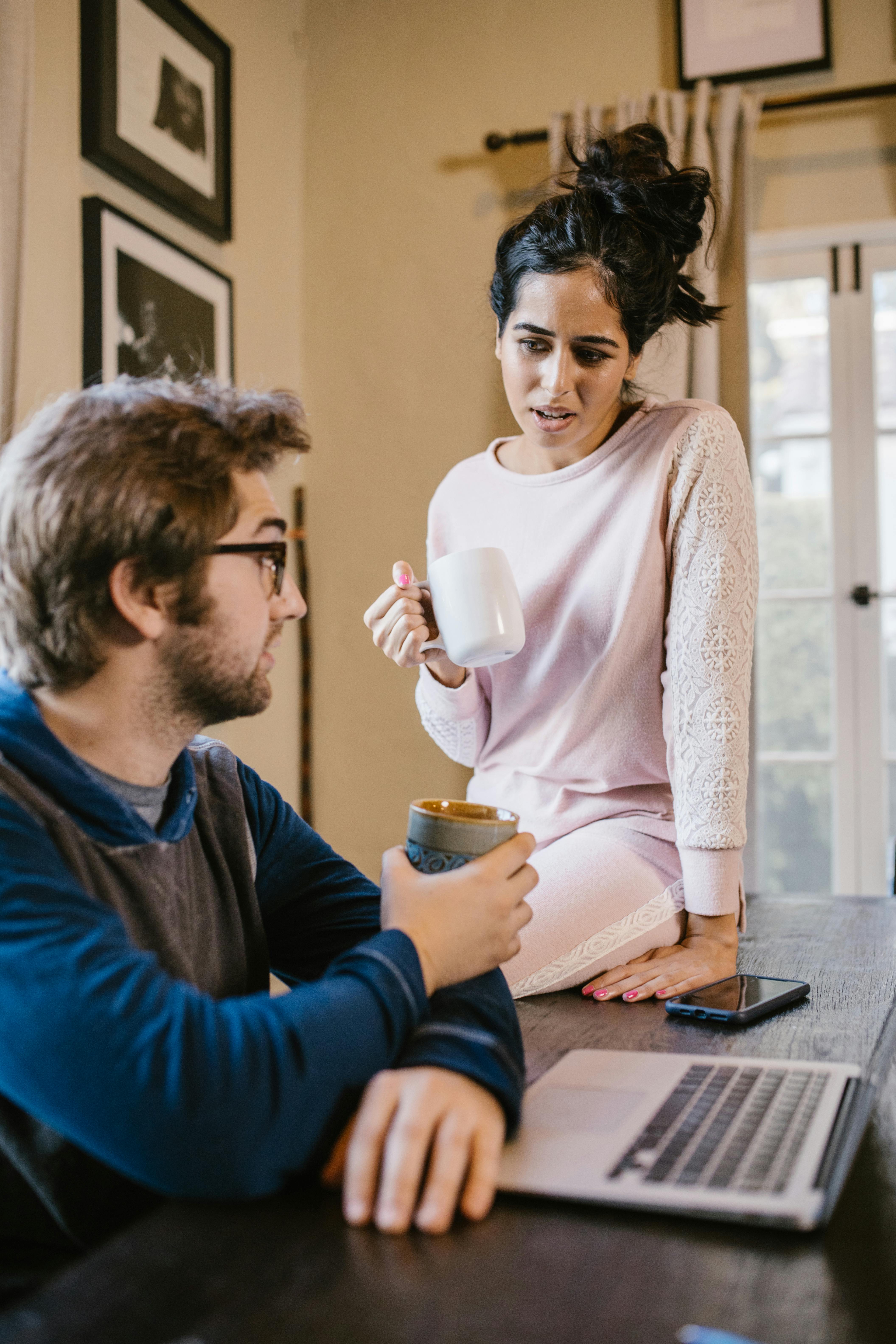 Couple Chatting Over Coffee at Home
