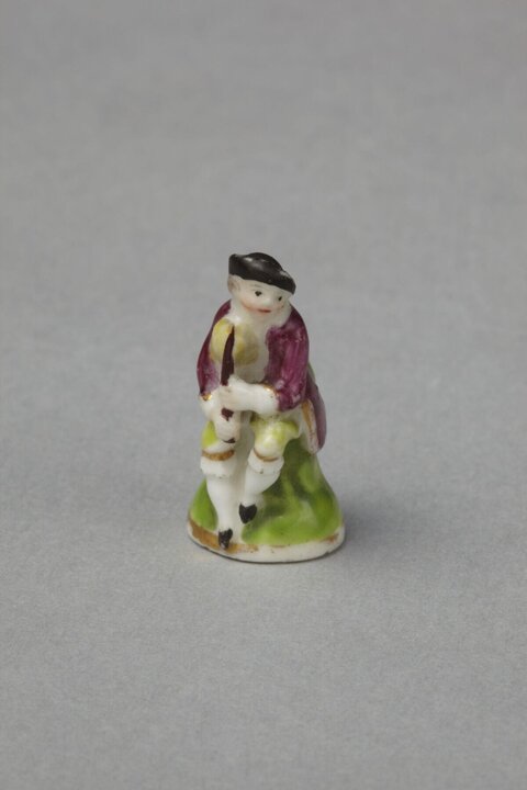 Miniature Porcelain Seated Man Figurine
