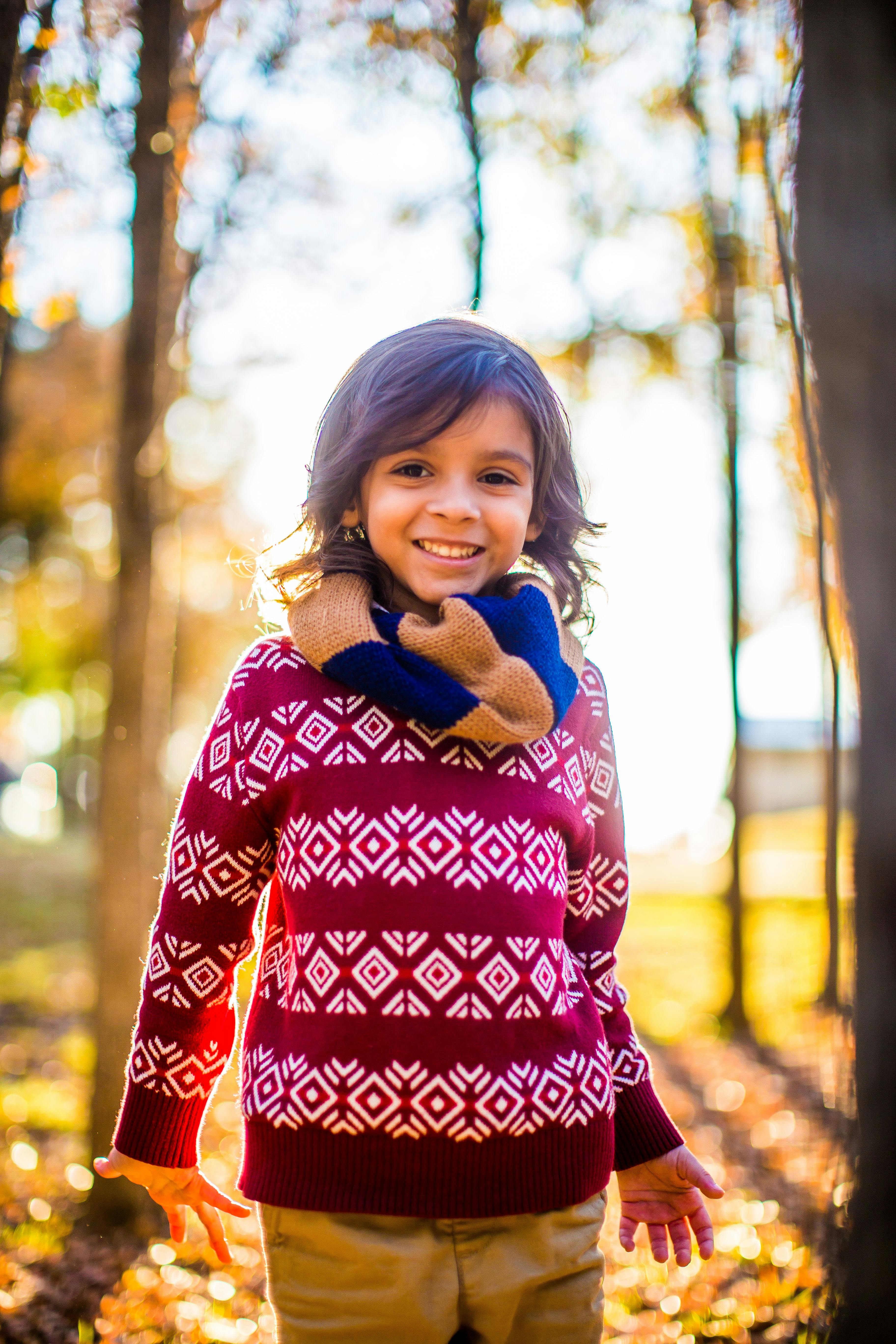 Smiling Child in Autumn Forest