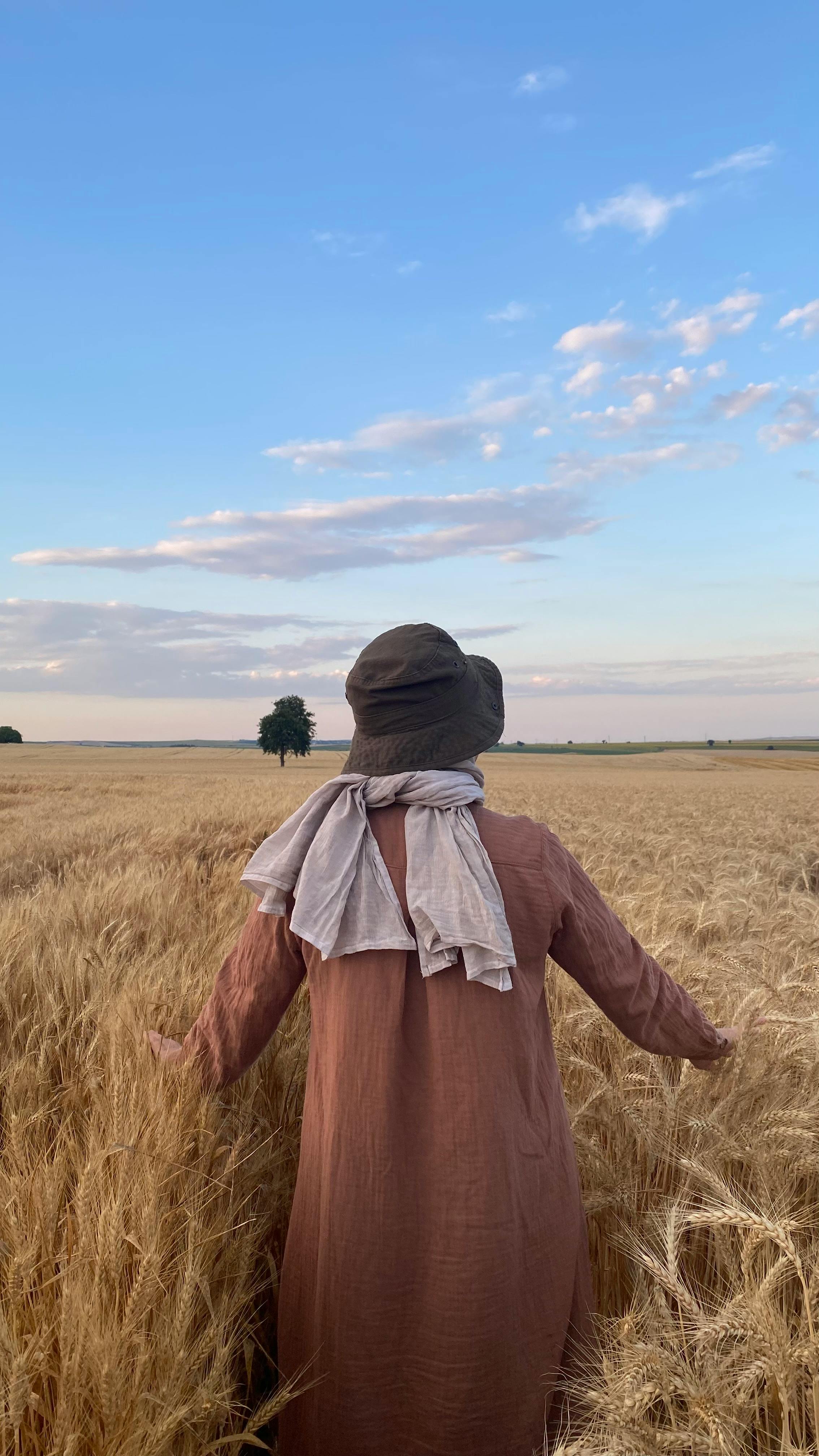 Person Standing in Golden Wheat Field