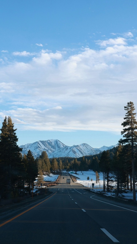 Highway Leading to Snow-Capped Mountains