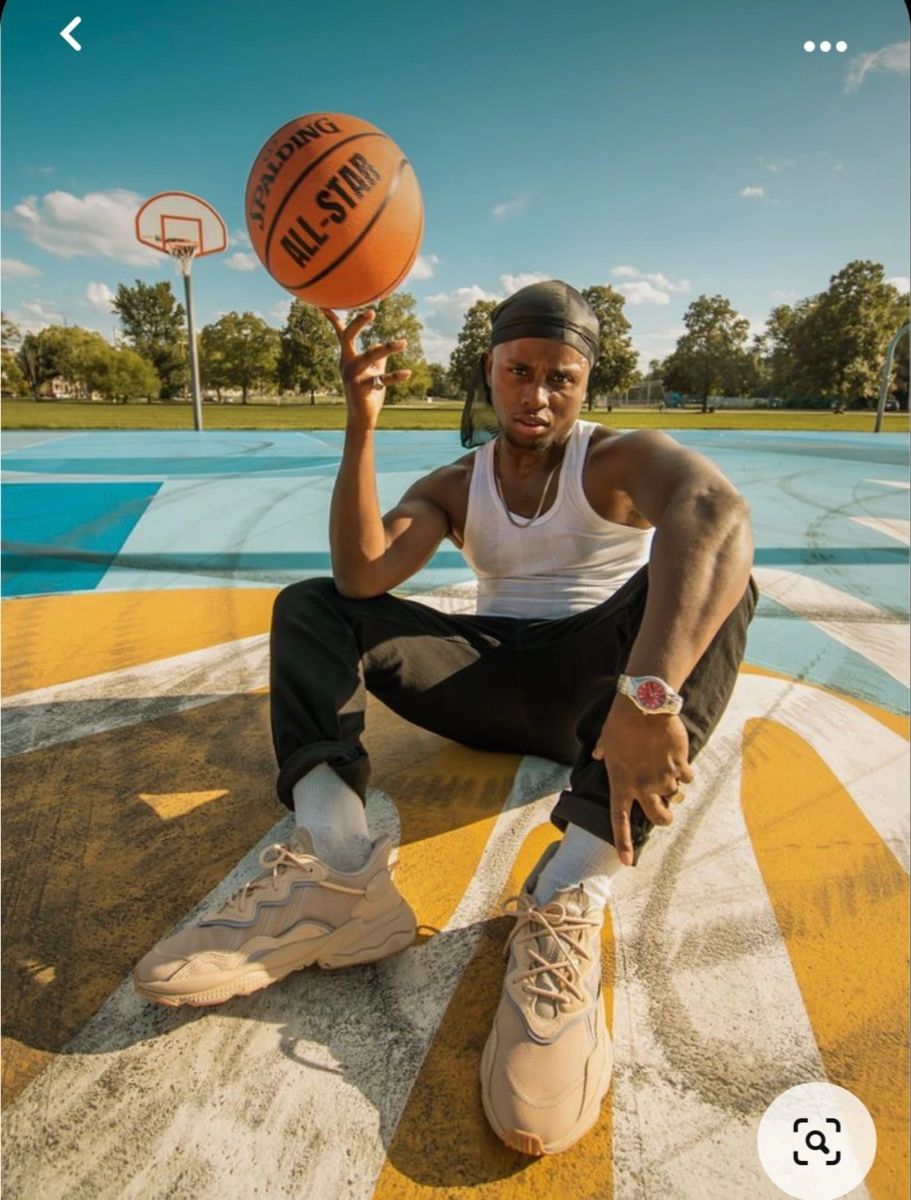 Man Spins Basketball on Outdoor Court