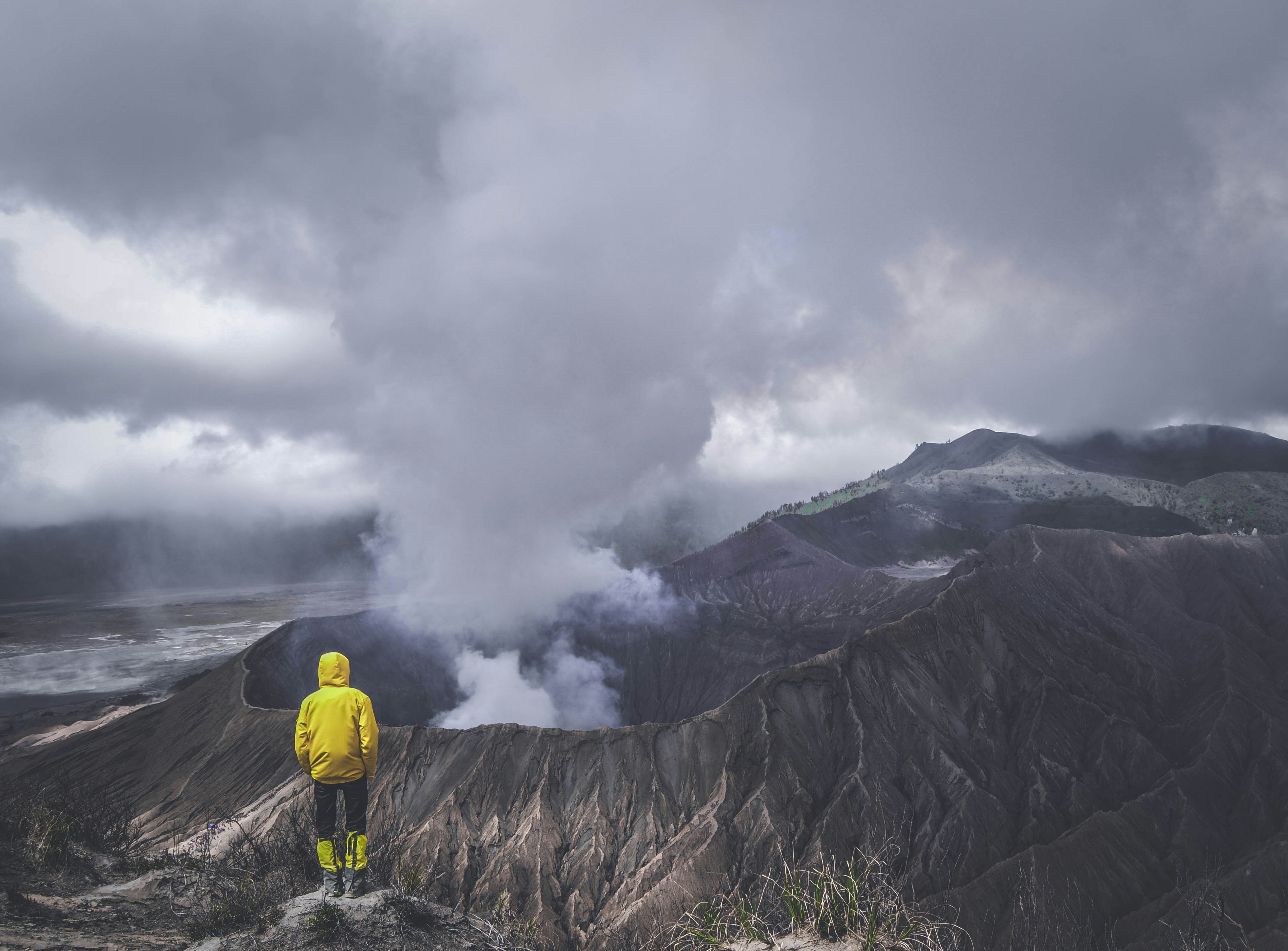 Hiker Overlooks Steaming Volcano Crater