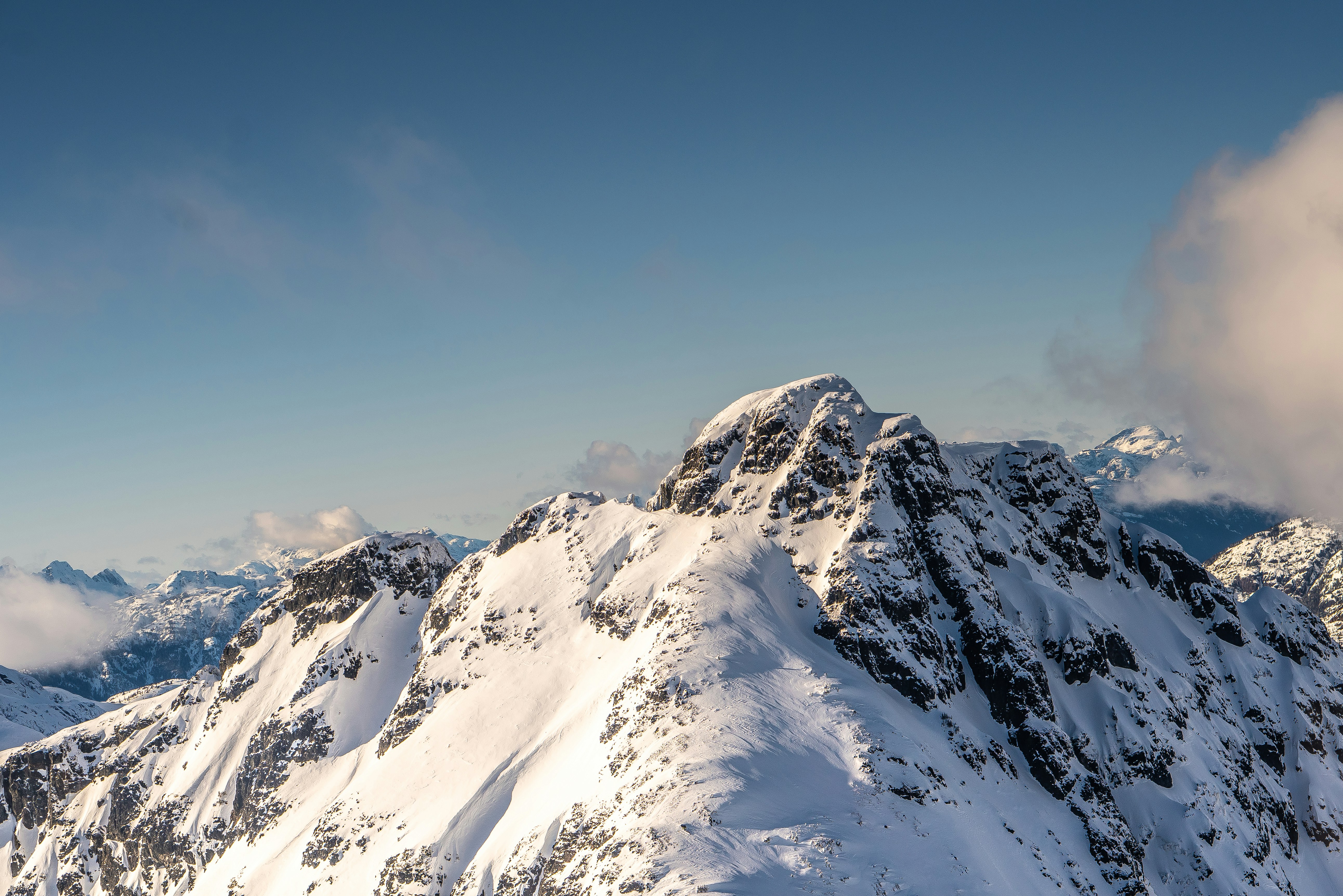 Snow-capped Mountain Peak Under Blue Sky