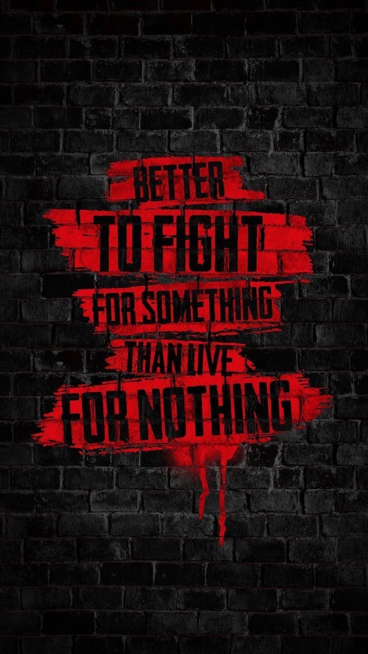 Motivational Quote on Black Brick Wall