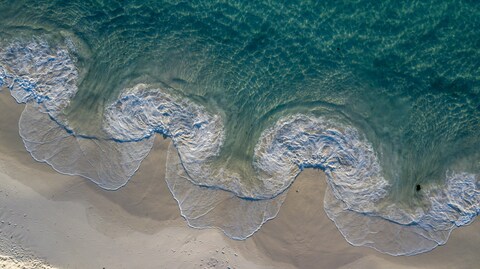 Aerial View of Waves on Beach