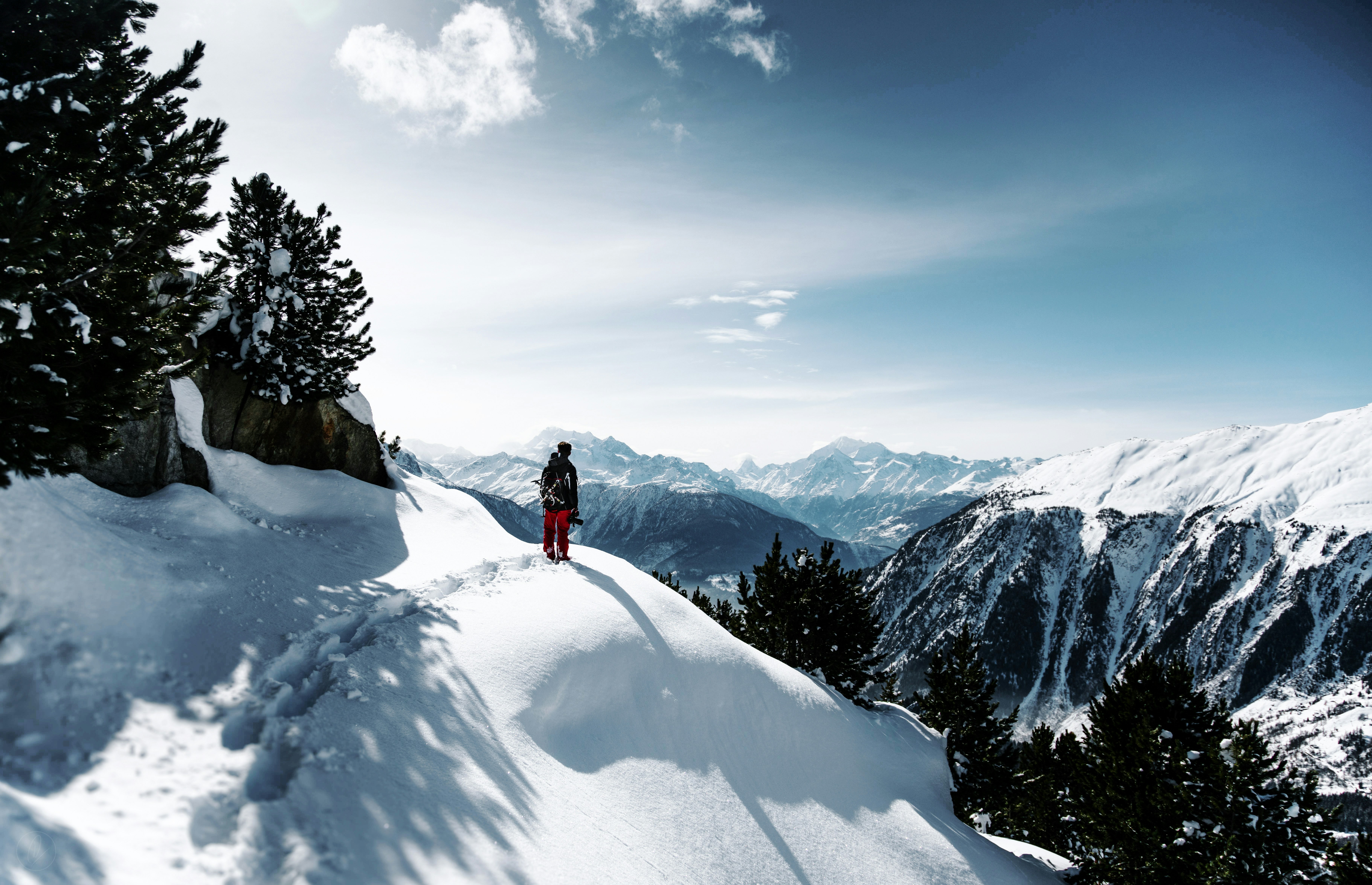 Hiker on Snowy Mountain Ridge