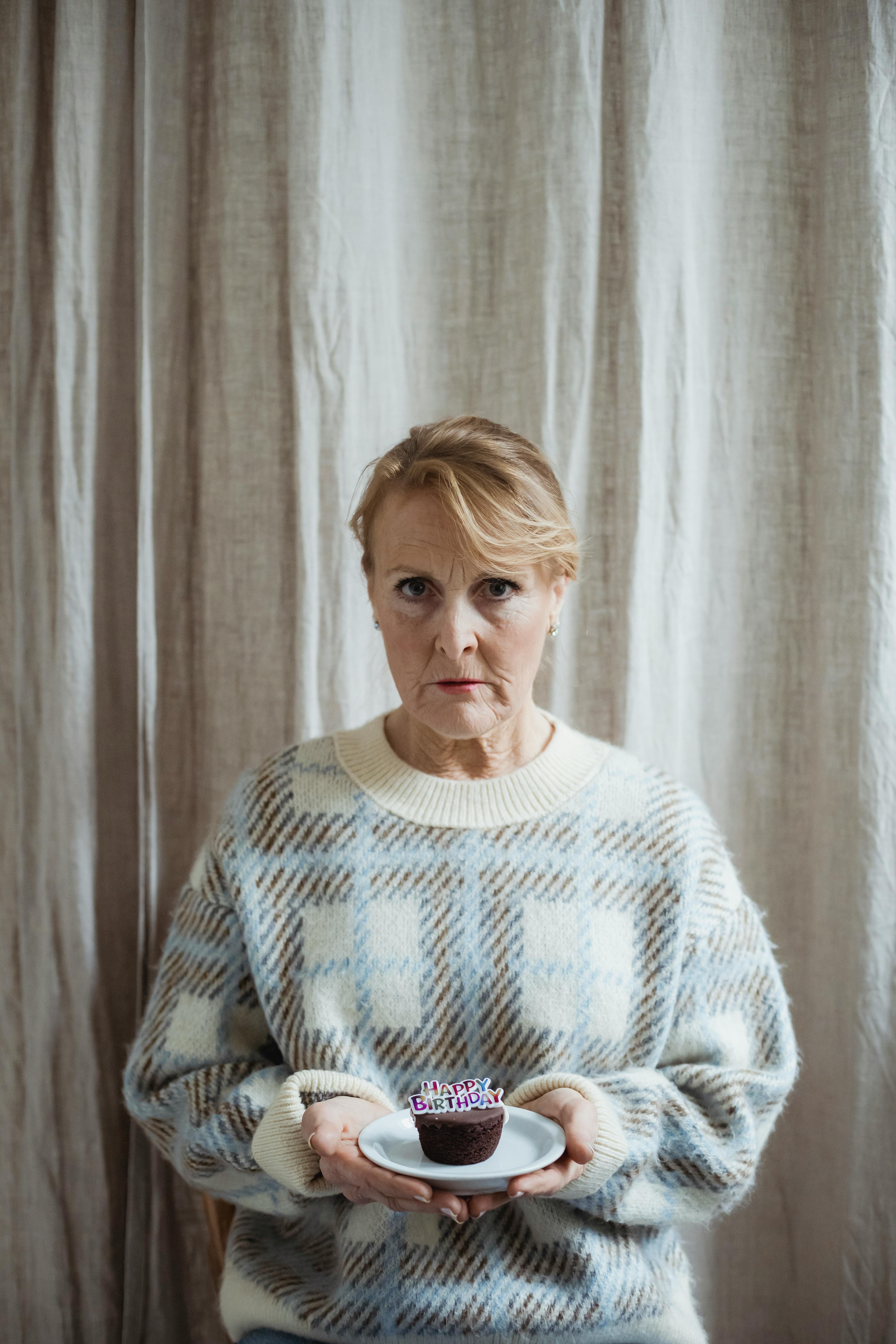 Woman Holding Small Birthday Cupcake