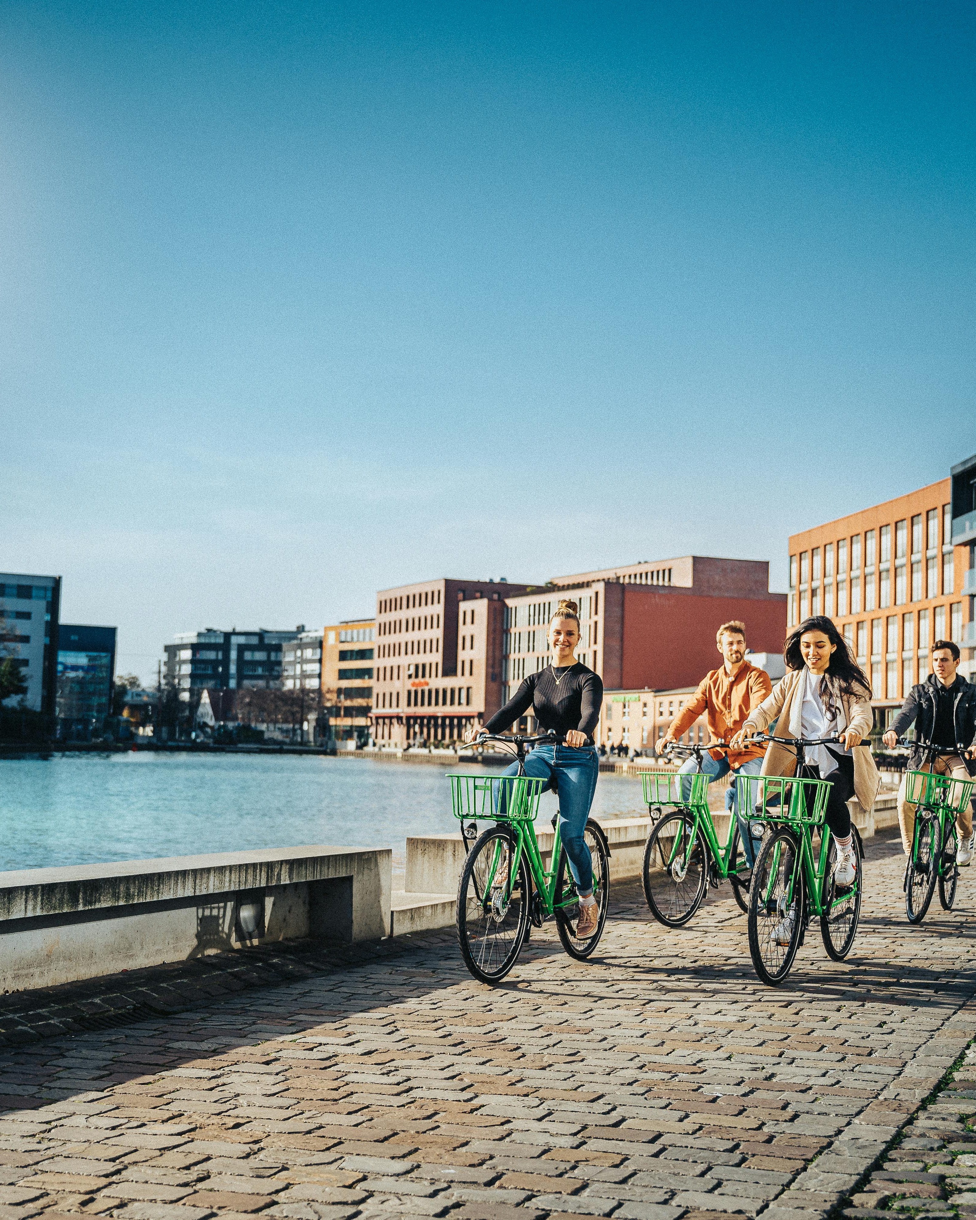 Group Cycling Along Urban Waterfront