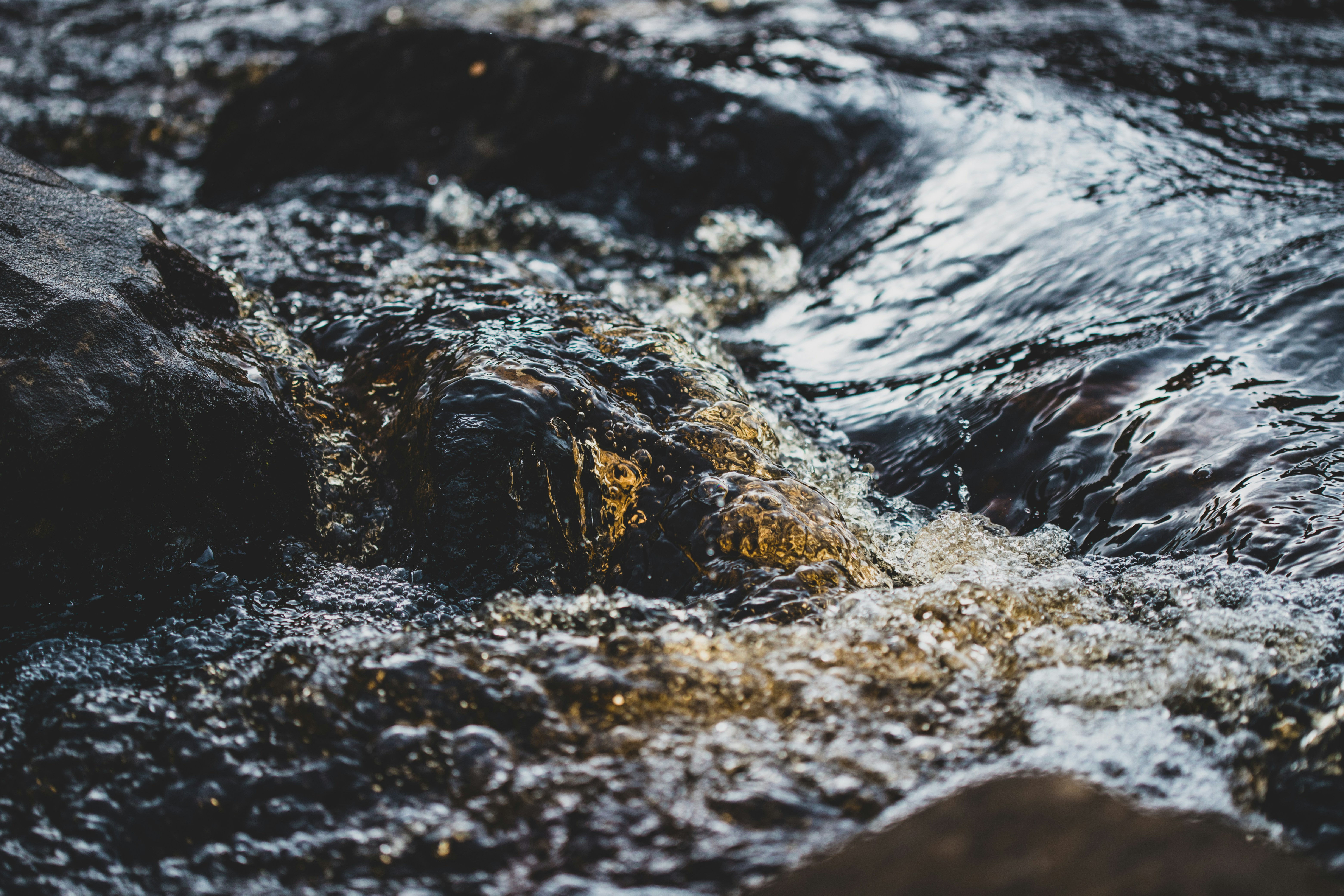Flowing Water Over Dark Rocks