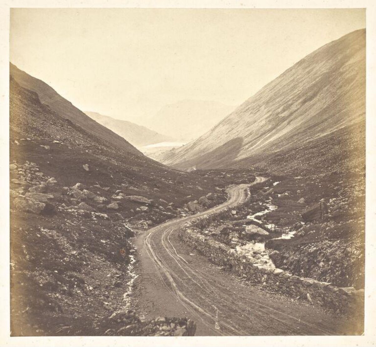 Winding Dirt Road in Mountain Valley