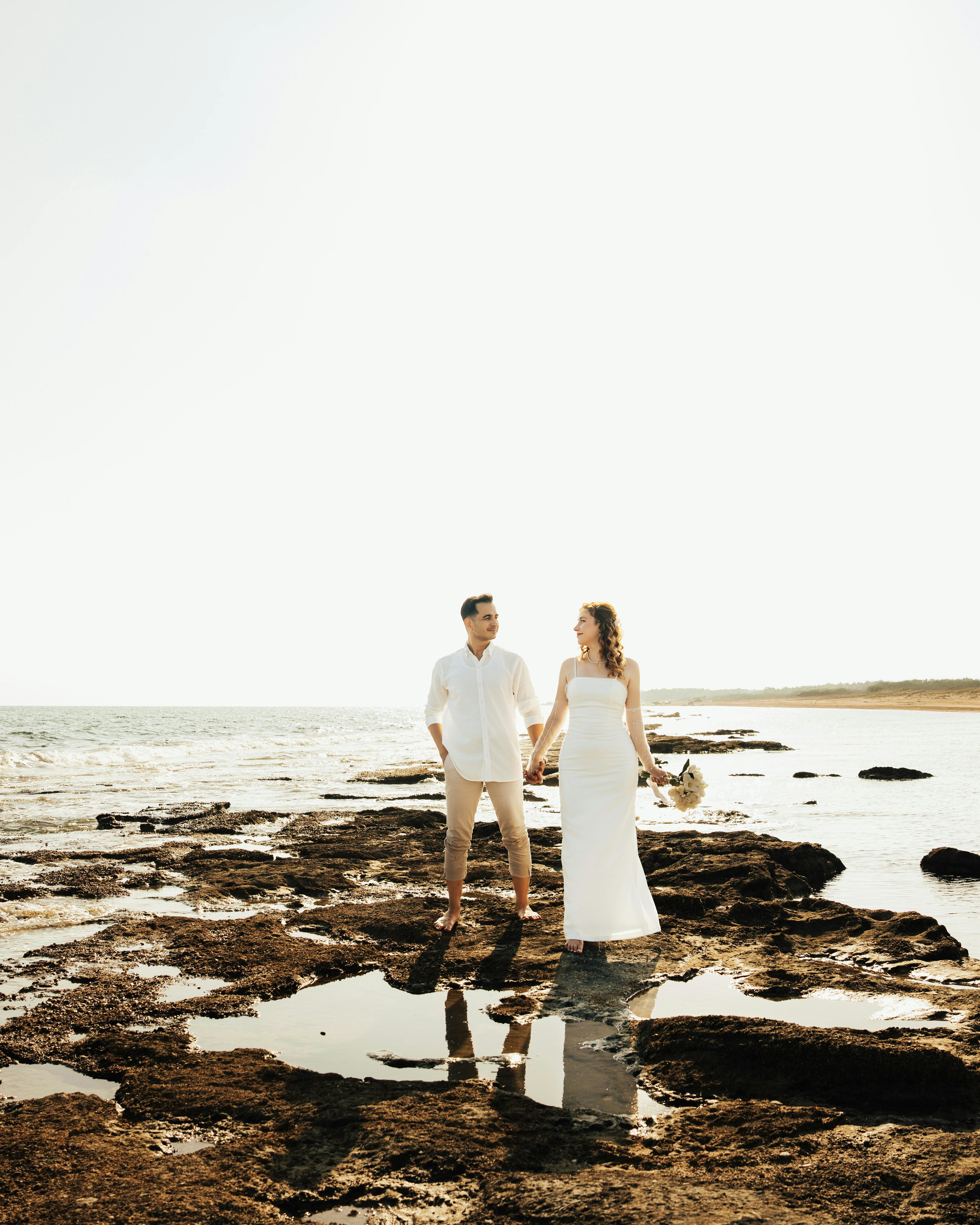 Bridal Couple on Rocky Ocean Shore