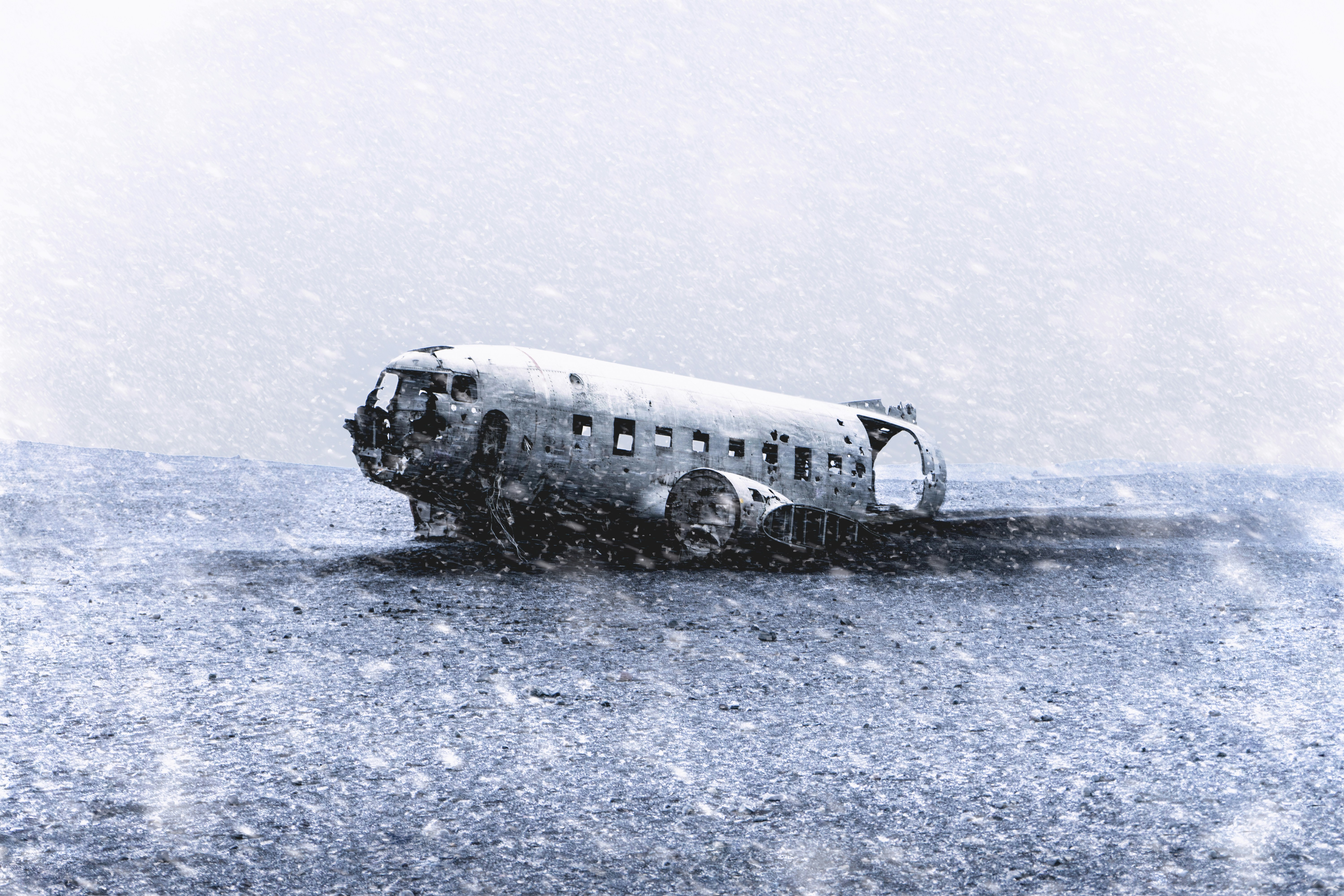 Wrecked Plane on Snowy Black Sand Beach