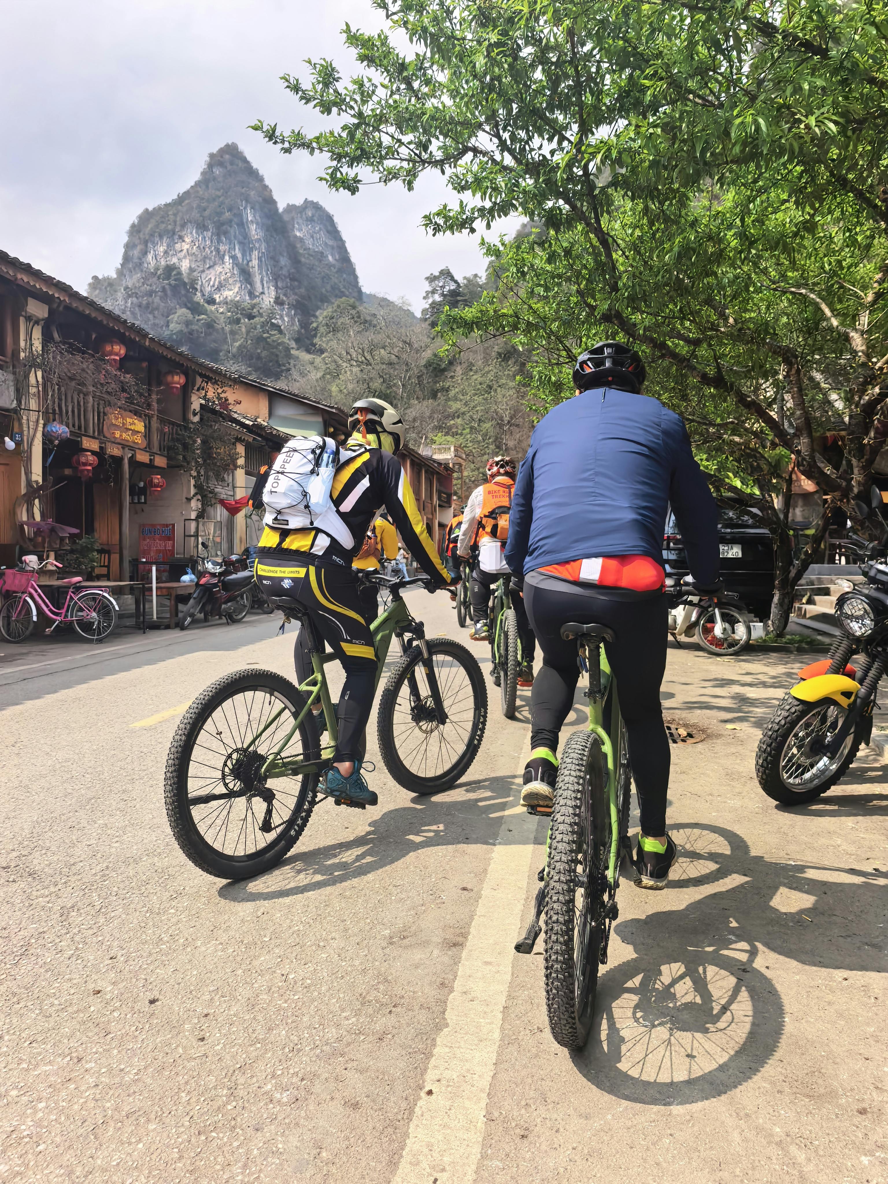 Cyclists Riding Through Mountain Village